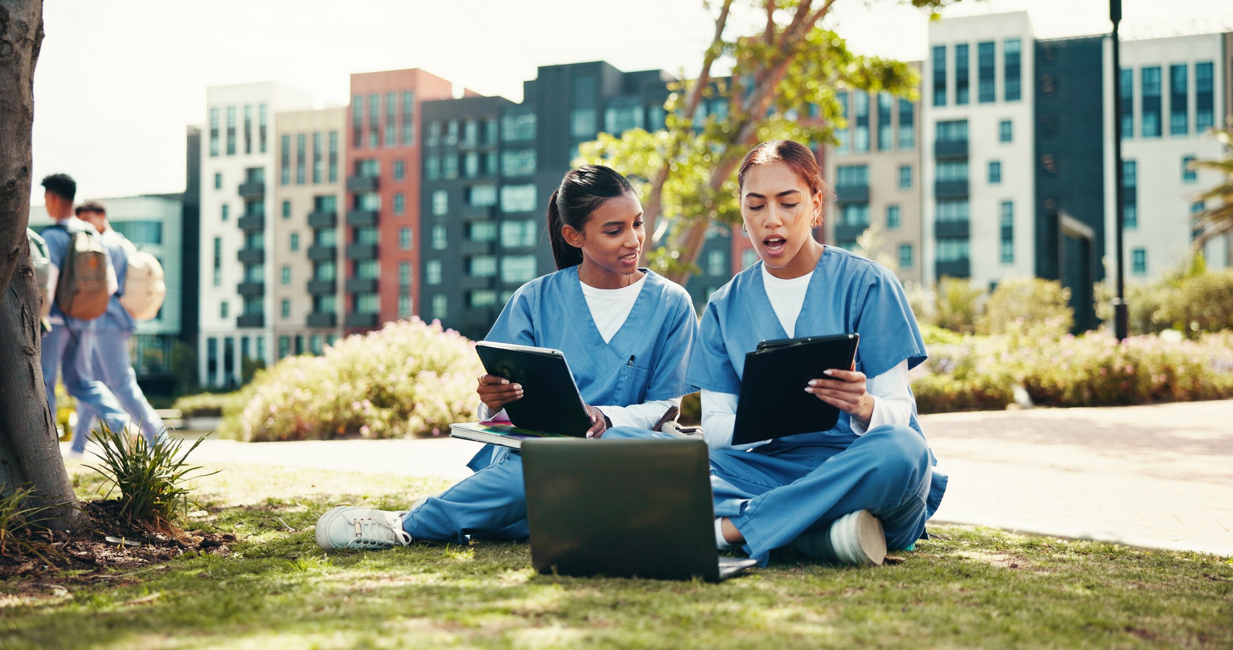 Medical student, studying and tablet with people in outdoor for college, healthcare and research. Scholarship, internship and doctors with students on hospital campus for laptop and education