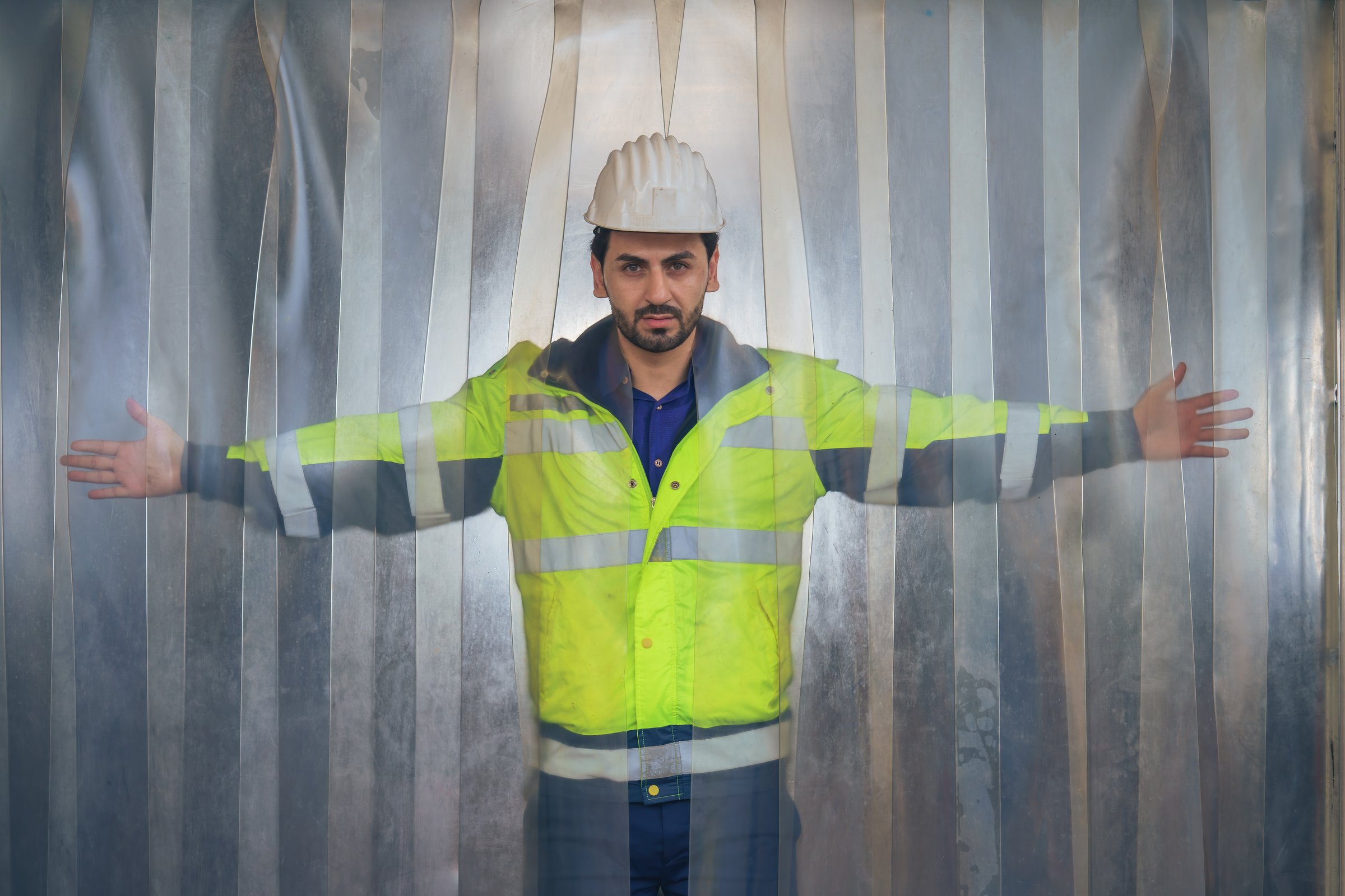 portrait of factory warehouse supervisor in front of gate curtains of tempurature control warehouse