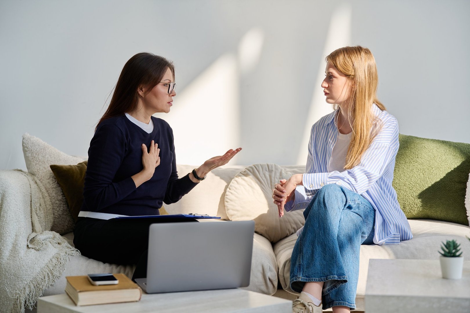 Young woman in mental session talking with professional psychologist. Female psychiatrist counselor social worker working with patient. Psychology psychiatry therapy treatment support help youth