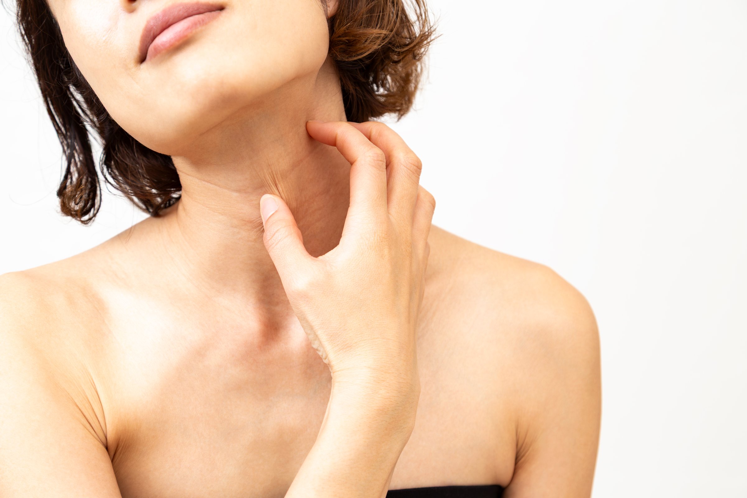 A woman suffering from an itchy neck.
