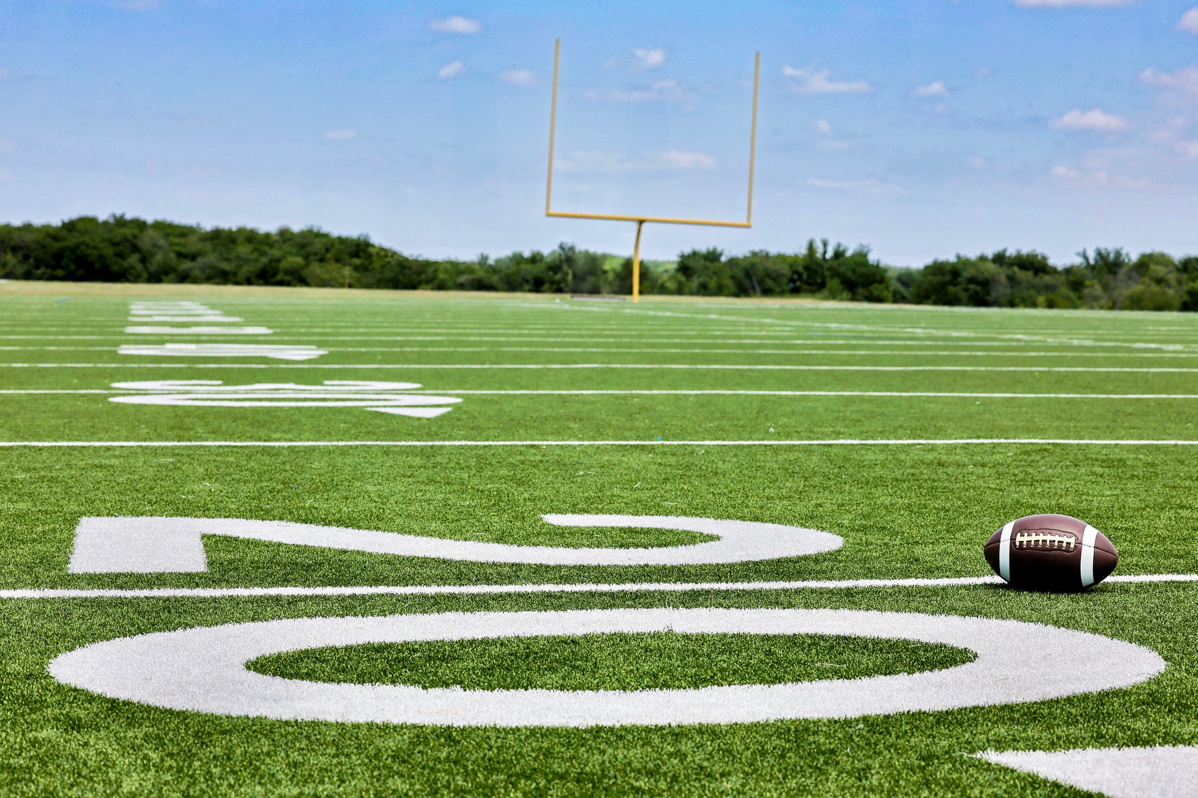 Playing football outside on a sunny day