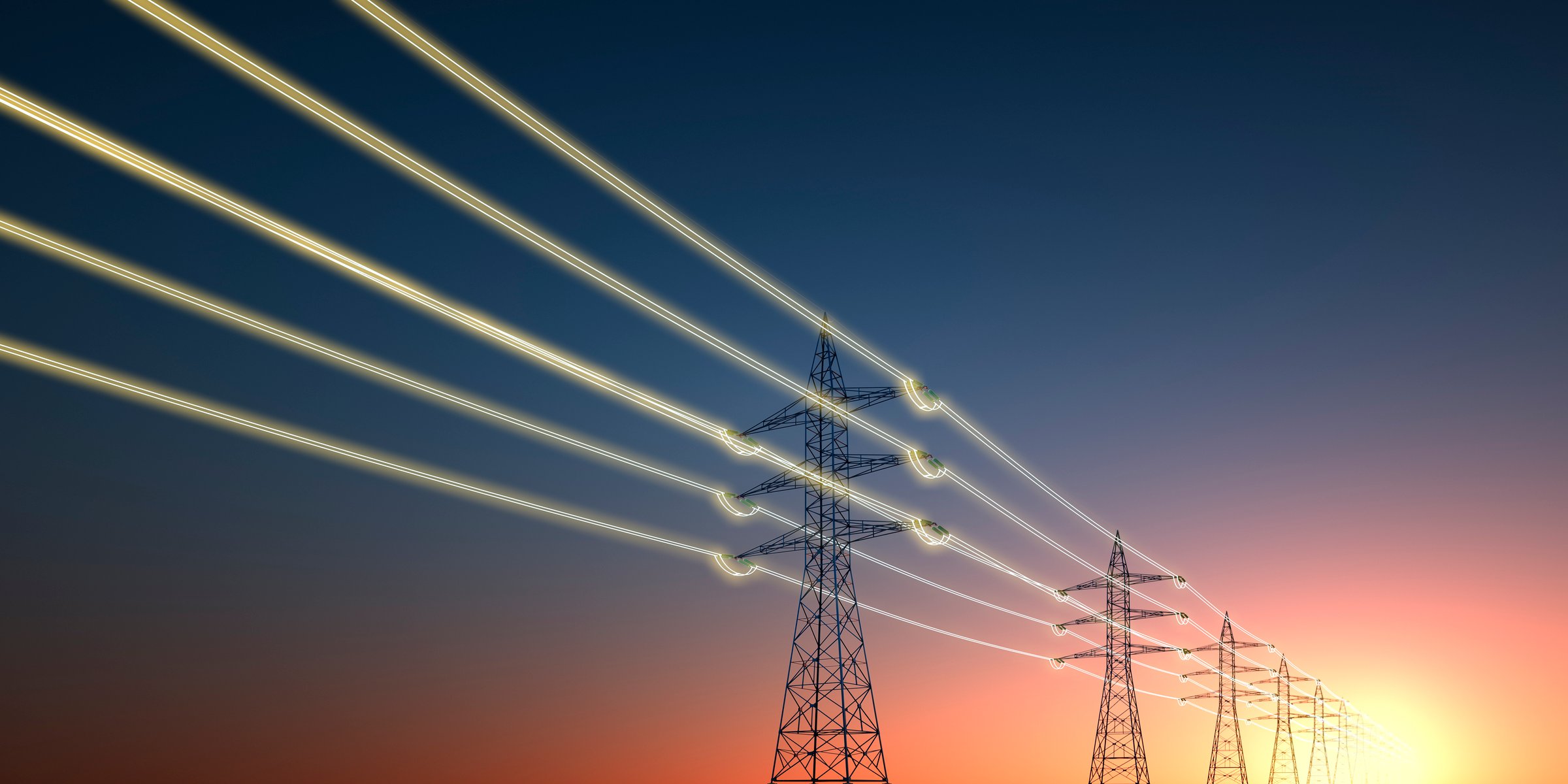 Electricity transmission towers with glowing wires against sunset sky - Energy concept