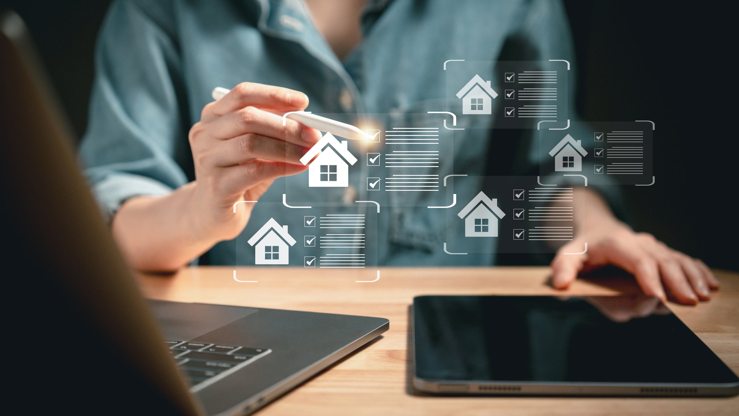 Close-up of individual using stylus to interact with virtual housing checklists on screen symbolizing real estate choice and digital property search