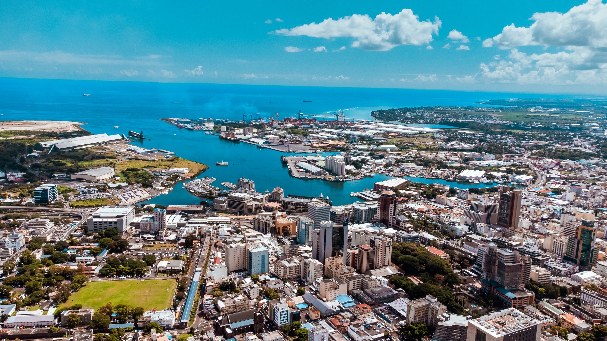 An aerial view of the port in Port Louis with blue Indian Ocean waters and a clear blue sky