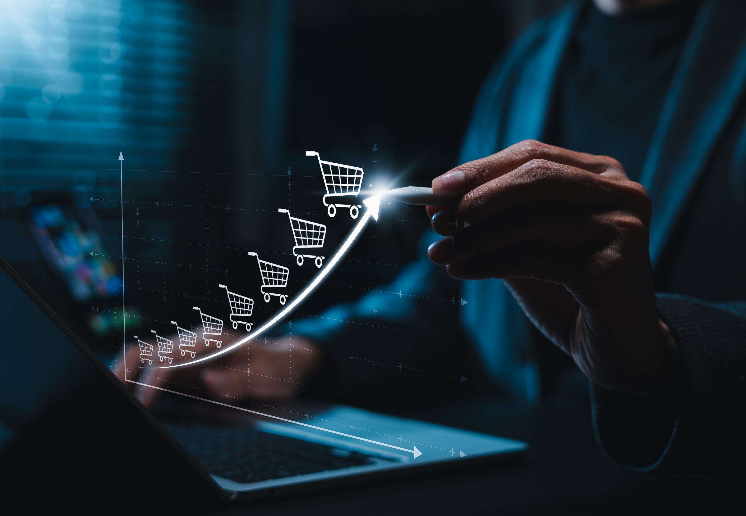 E-commerce growth concept. Graph with shopping cart icons increasing upward symbolizing increasing online sales, digital retail trends, ecommerce success and business growth in internet marketplace.