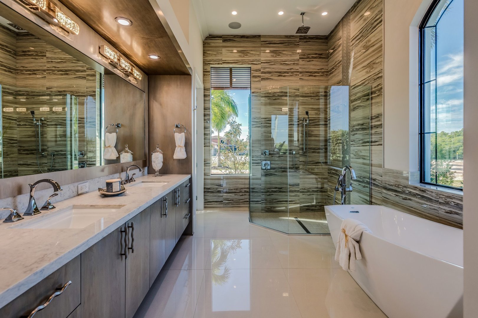 Free standing tub and big glass shower in master bathroom with amazing views