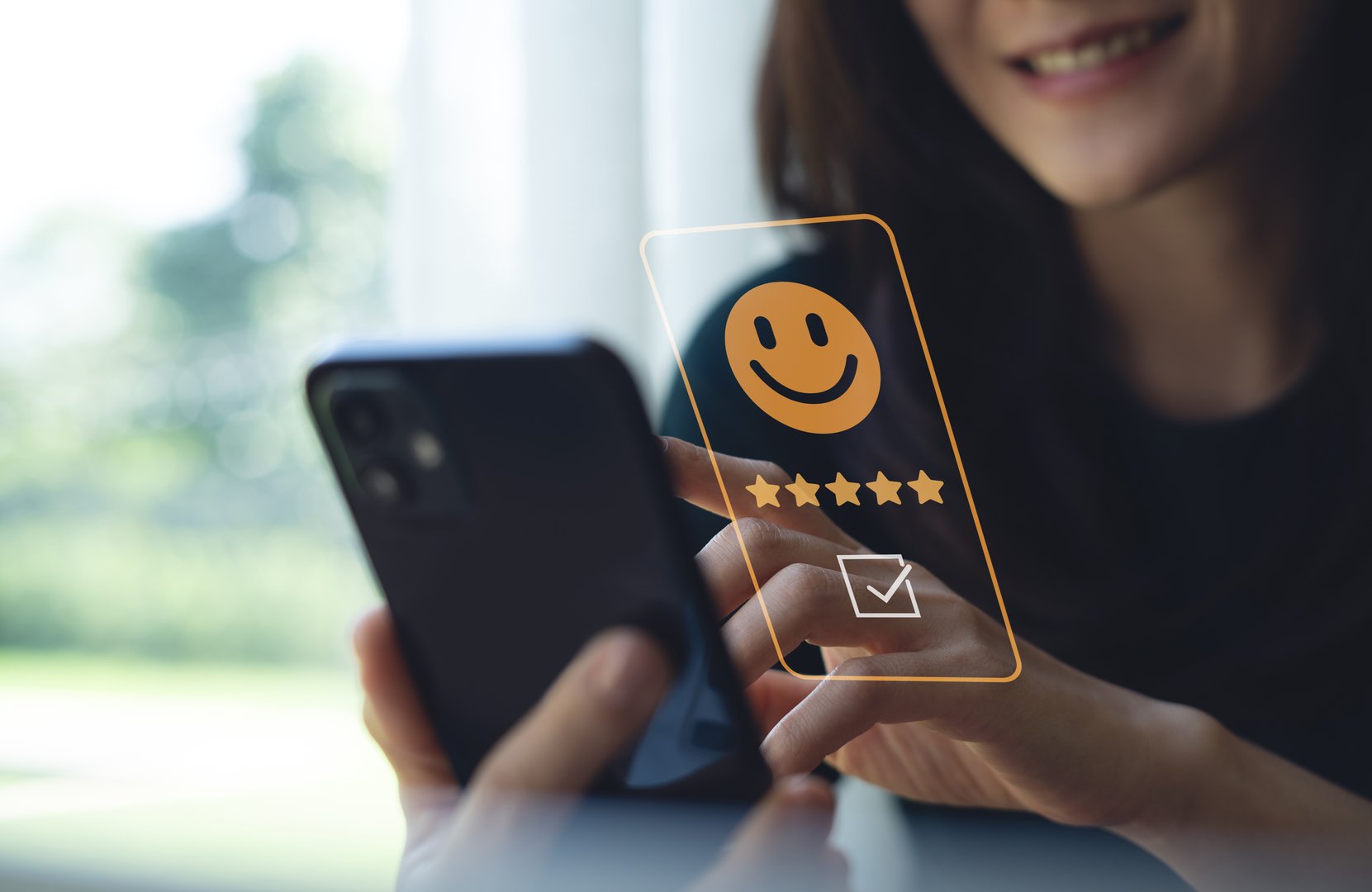 Customer review satisfaction feedback survey concept. Customer pressing smile face and five star on mobile phone for customer review. Customer satisfaction survey, service experience rating