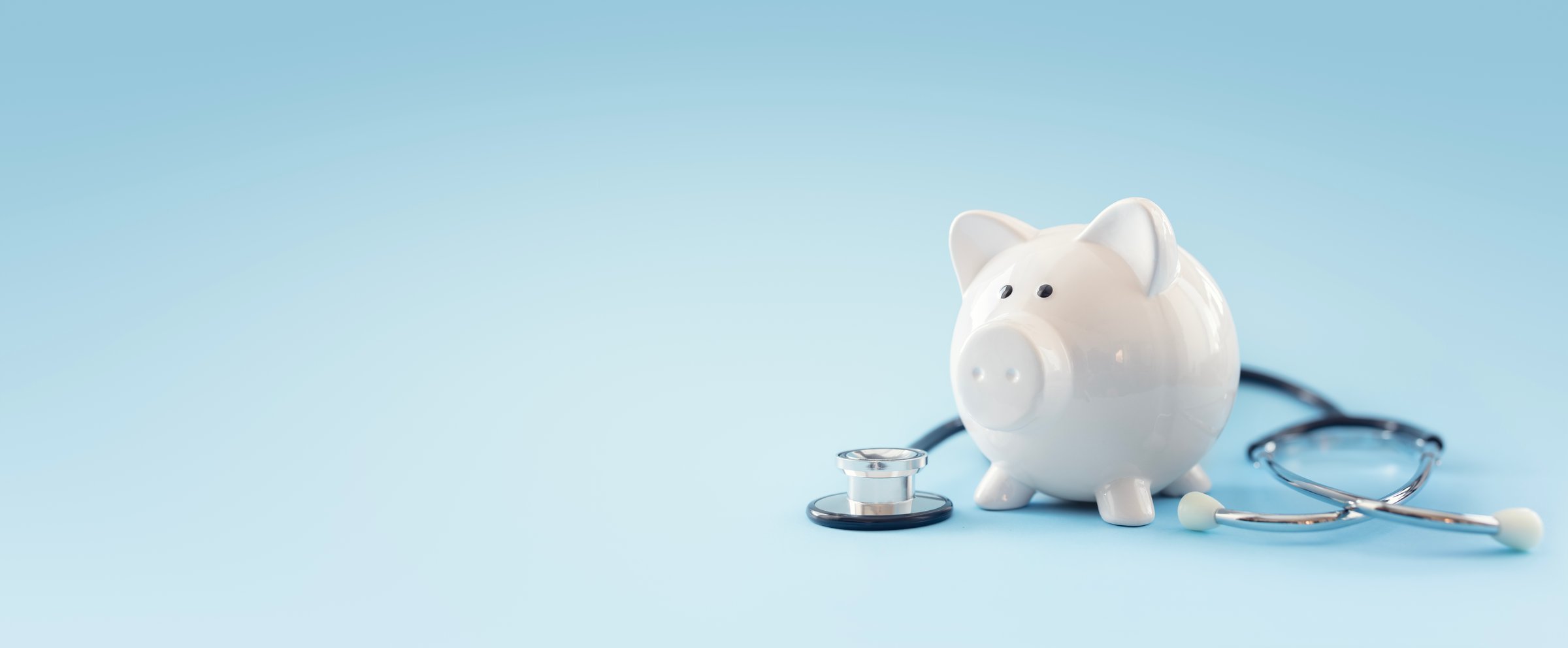 Piggy bank with stethoscope background concept for financial health check-up or saving for medical insurance costs