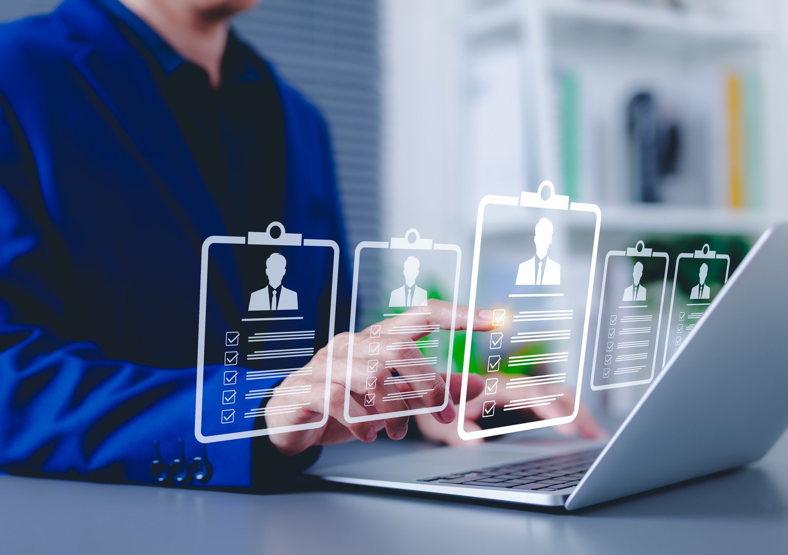 Recruitment and candidate selection concept. Businessman interacts with digital interface with multiple candidate profiles on laptop. Represents online recruitment, HR technology, hiring process,
