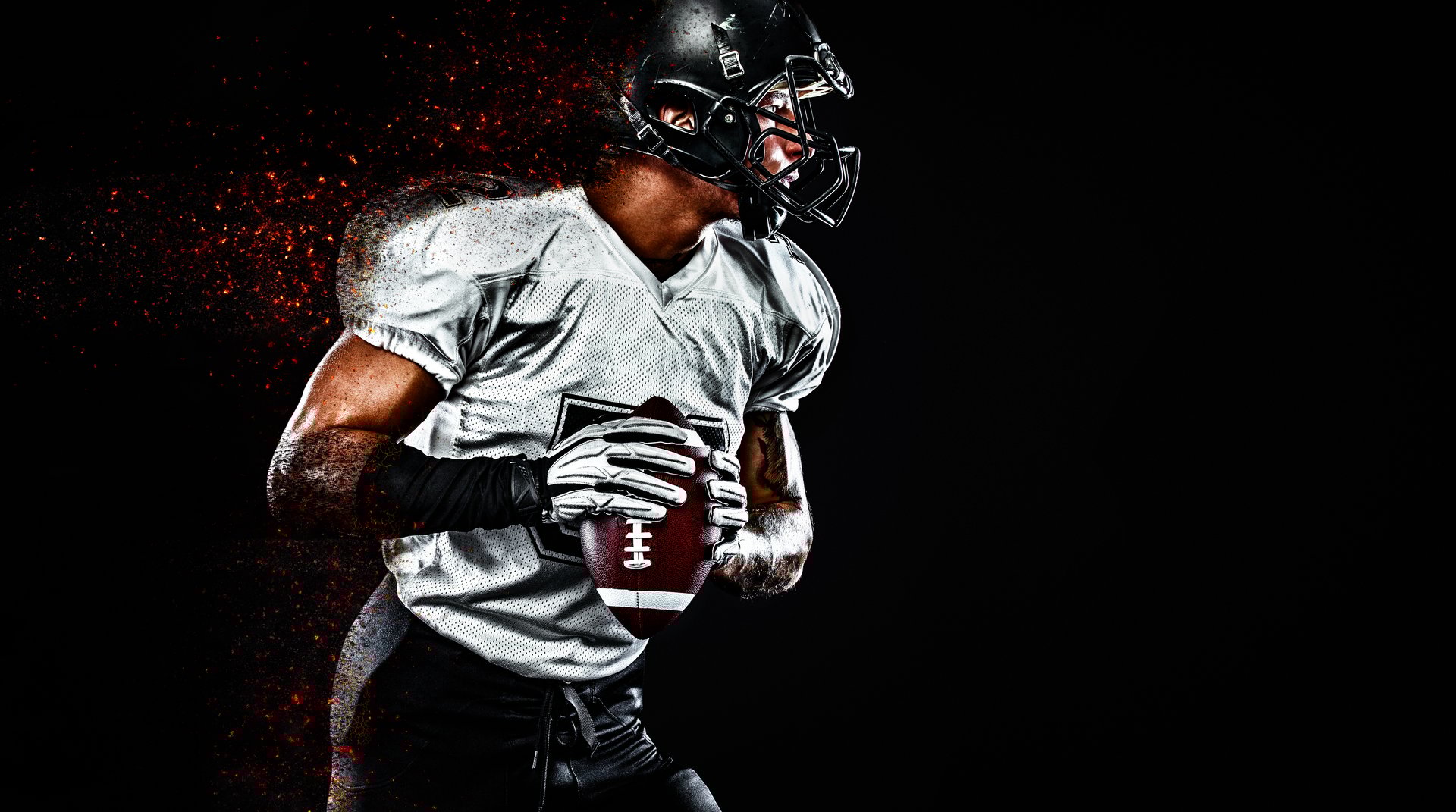American Football player on stadium with smoke and lights.
