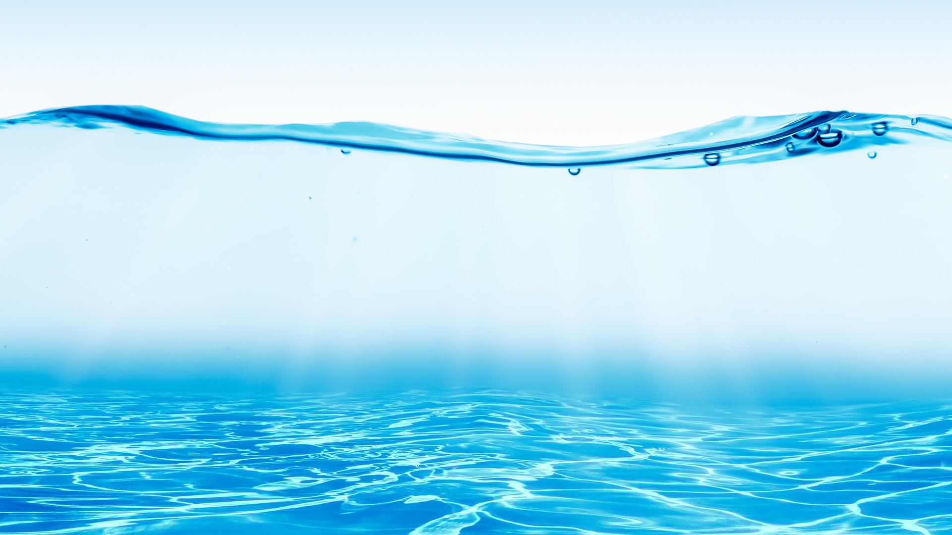 blue waterline with transparent underwater view, sunlight reflections on sand floor, abstract water wave background with copy space for travel destination, vacations and body care