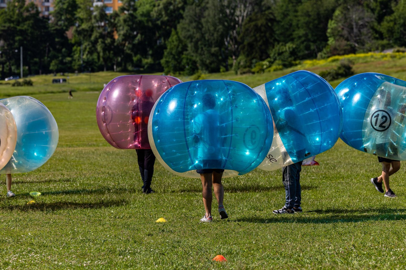 People playing bubble football outdoors