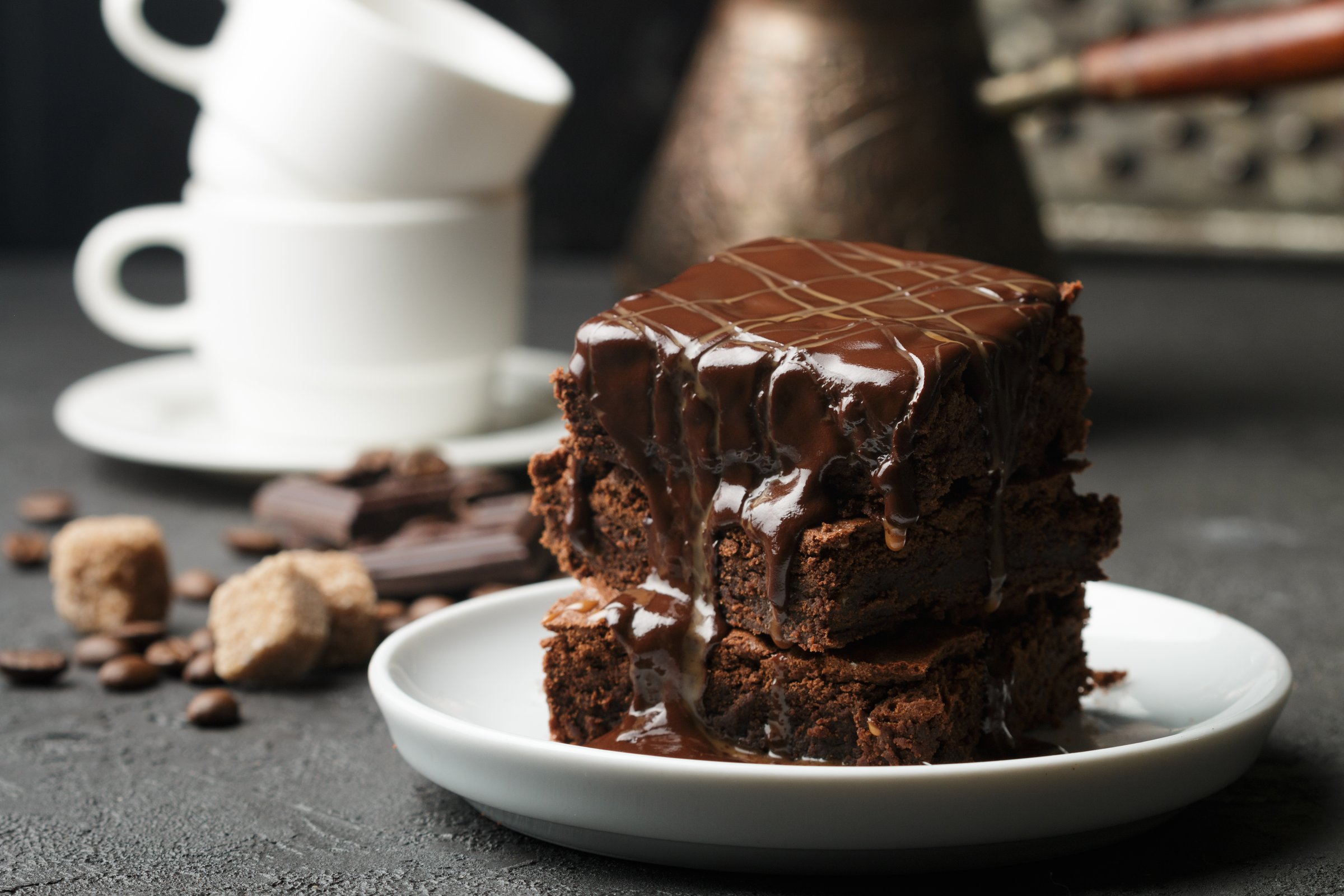 Delicious homemade brownie with chocolate sauce and caramel on the table. Selective focus