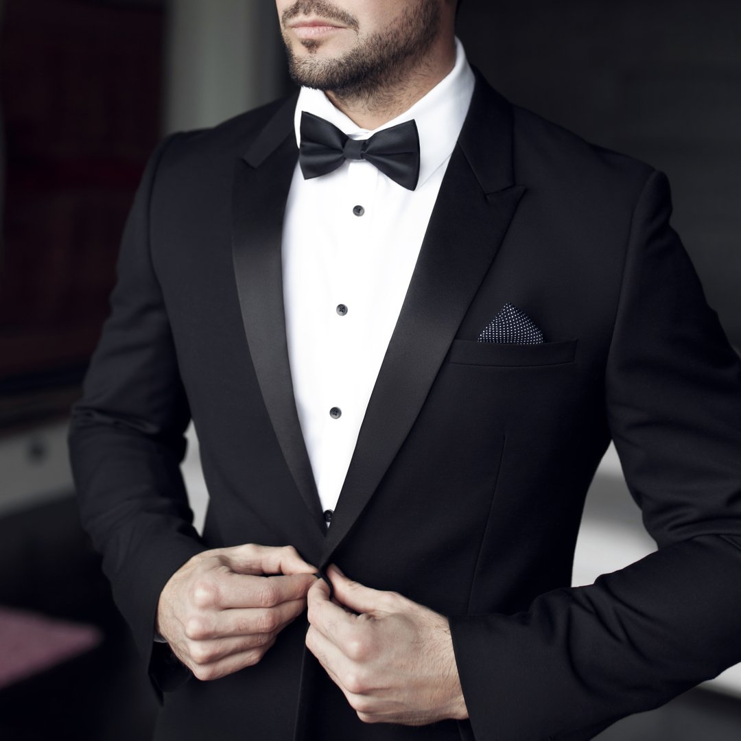 Man in tuxedo and bow tie posing