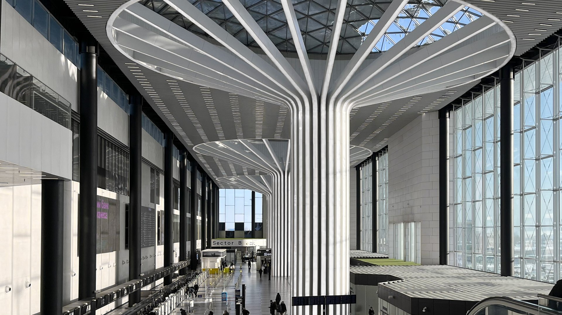 Modern airport terminal interior with contemporary architecture. Airport design and construction. Travel and transportation concept for aviation industry.