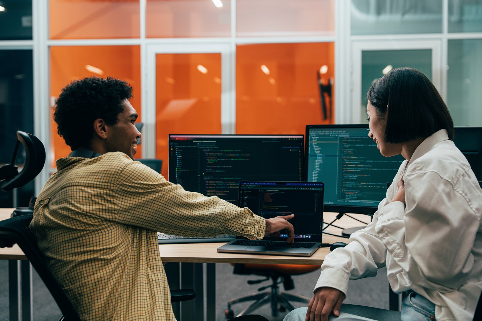 Cinematic image of a programming office with young programmers and software engineer working on a new project for a start up business.