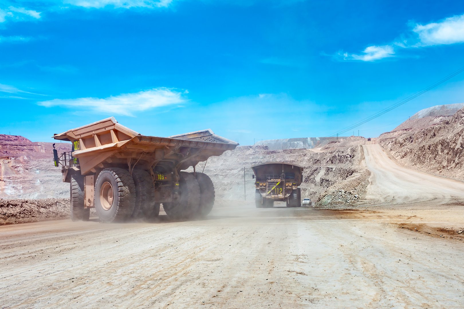 Dump trucks at an open-pit copper mine.