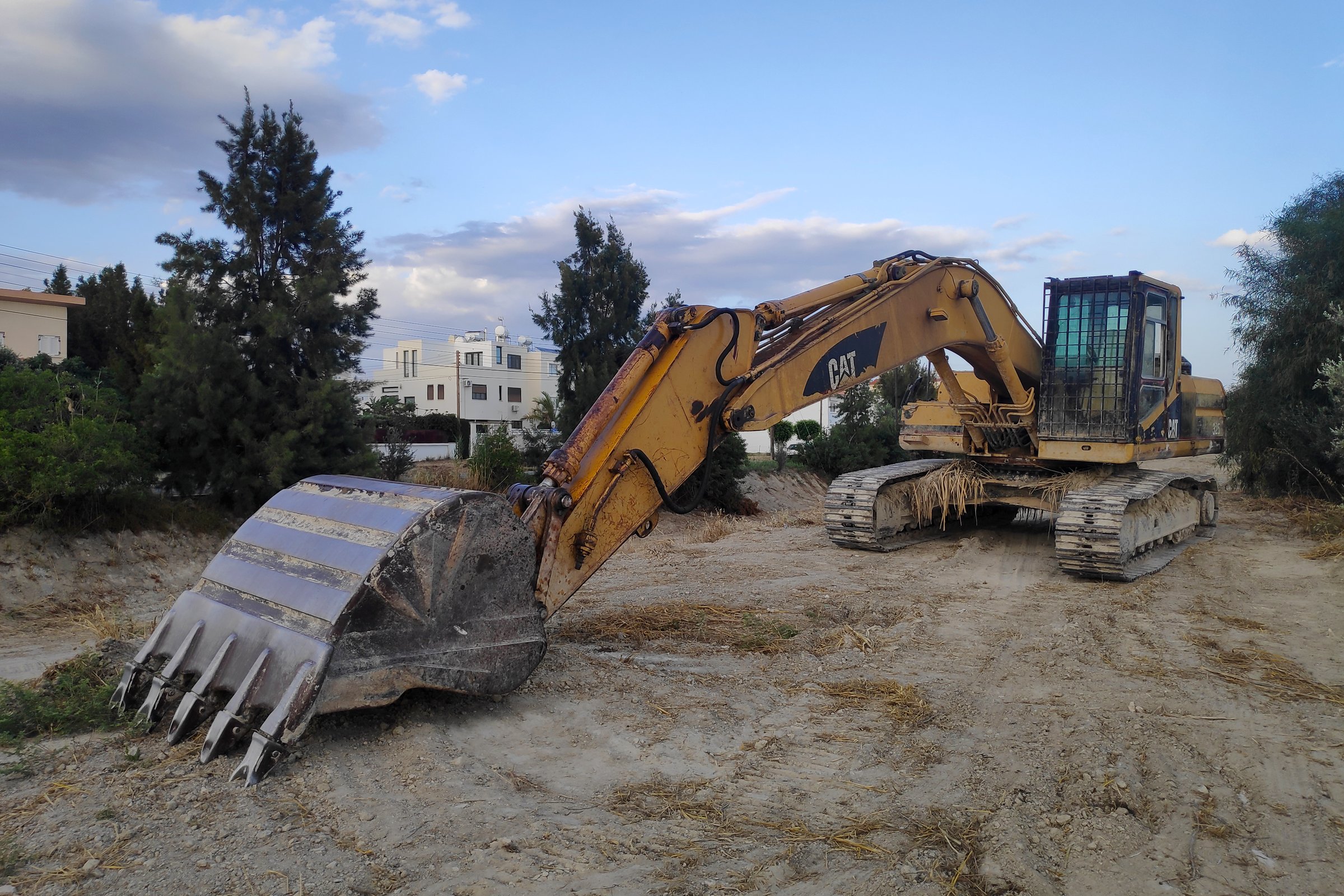 Larnaca, Cyprus - May 24 2024: The Caterpillar 325 is a medium hydraulic excavator manufactured by Caterpillar Inc.