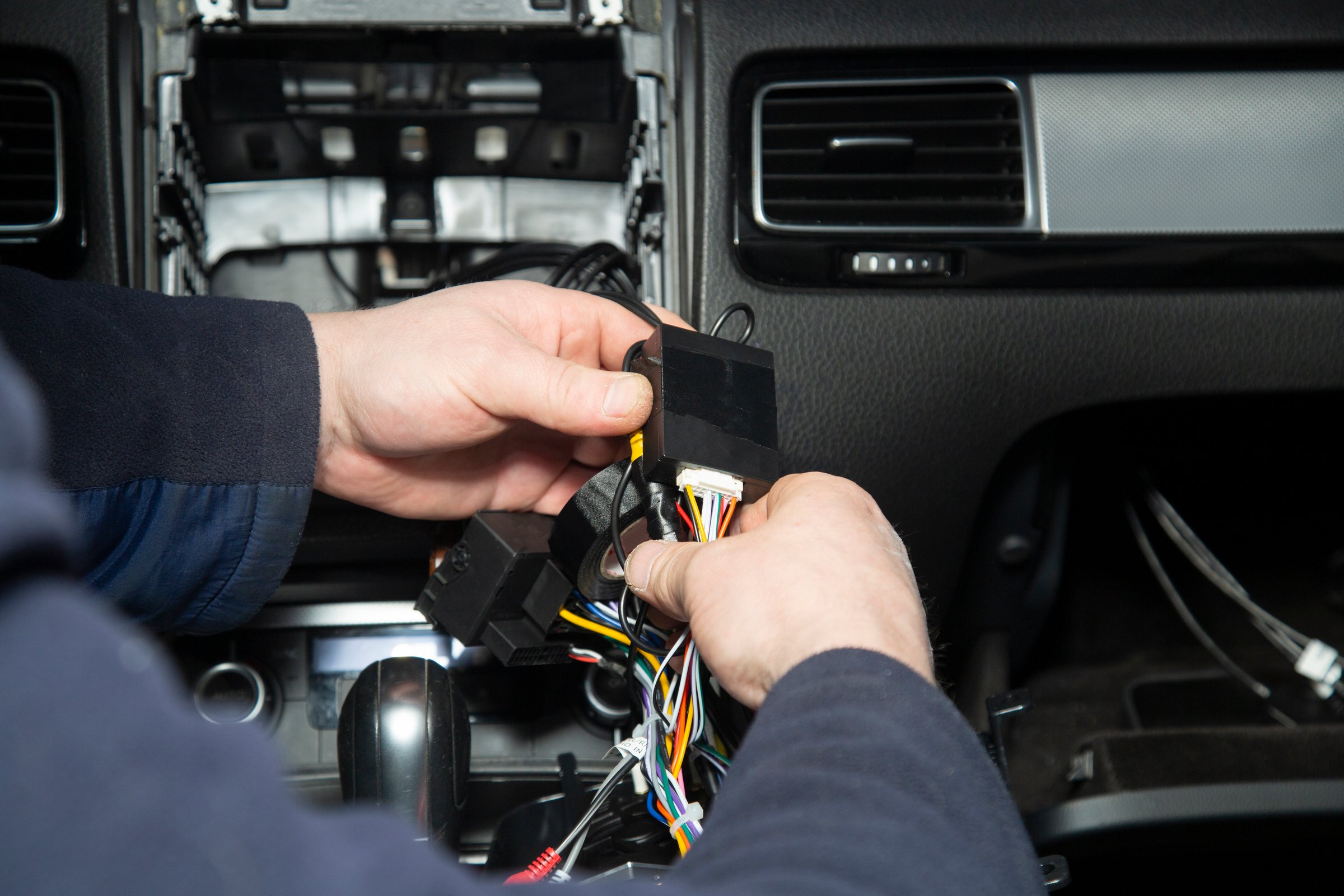 Installation of a modern multimedia system with a rear-view camera on the car. The installation center.
