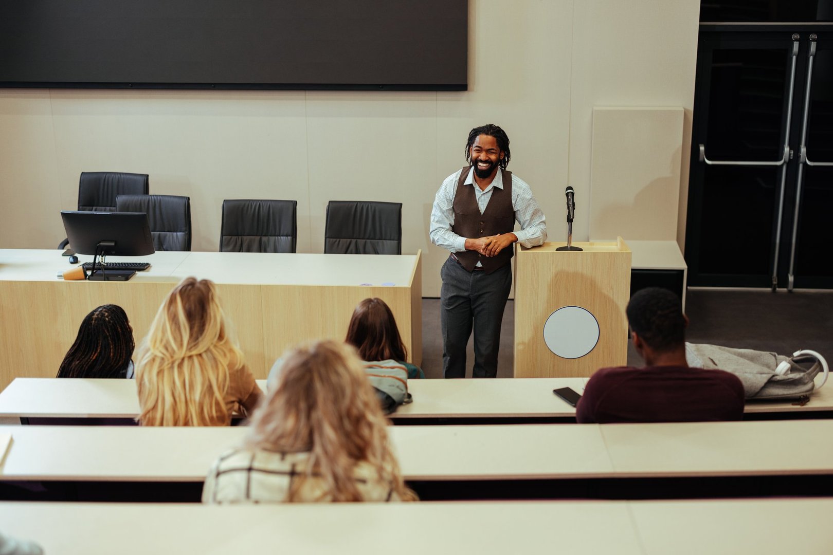 University professor engaging students while delivering an informative lecture in a dynamic classroom setting, fostering education and learning