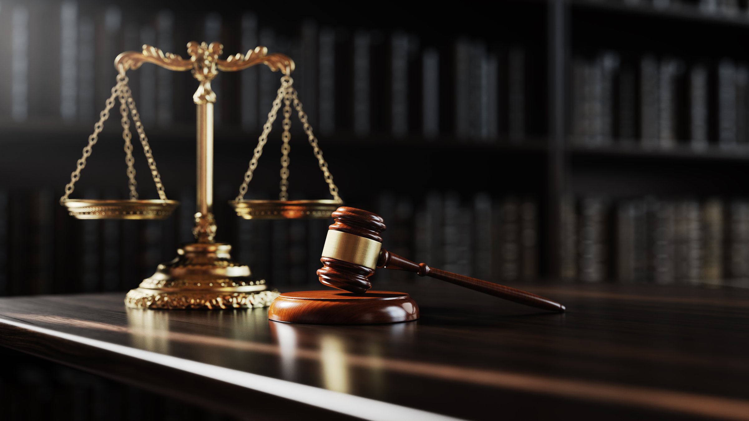 Legal concept: Scales of justice and and the judge's gavel hammer as a symbol of law and order on the background of books.