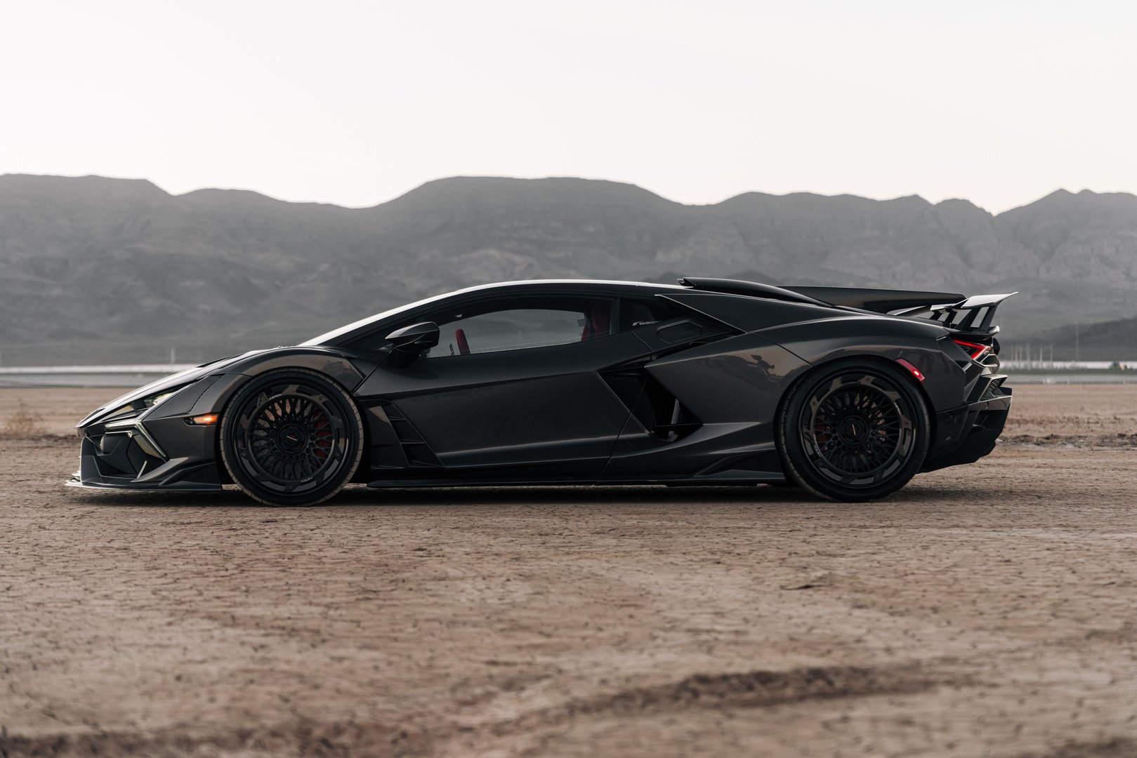 Las Vegas, Nevada, USANovember 10, 2025Black Lamborghini Revuelto parked in the desert showing the black wheel and fender
