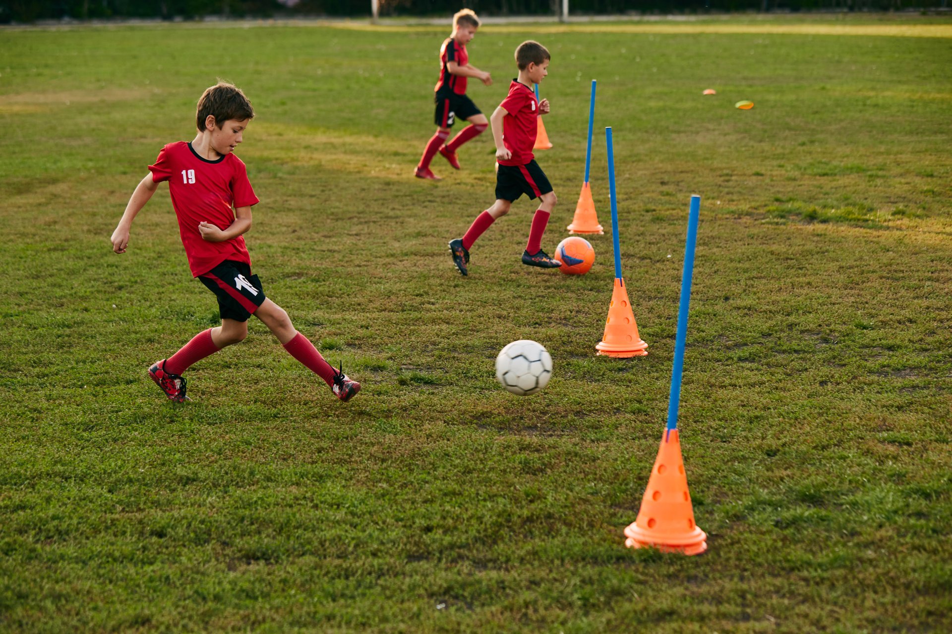 Kid soccer player dribbling ball