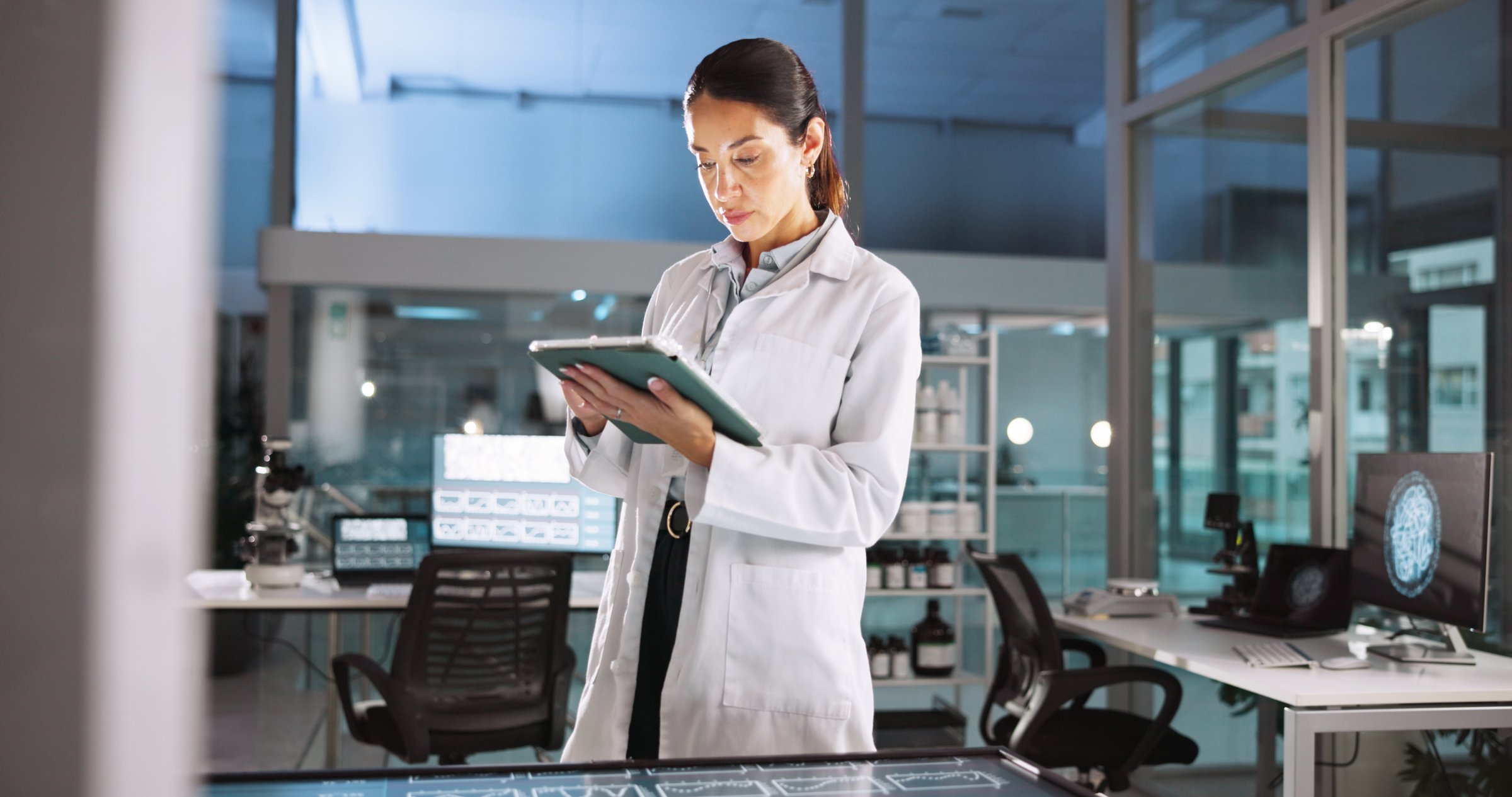 Woman, scientist and check tablet in lab for research, medical investigation and pharmaceutical report. Person, digital and biology studying, information and experiment feedback for neurology results