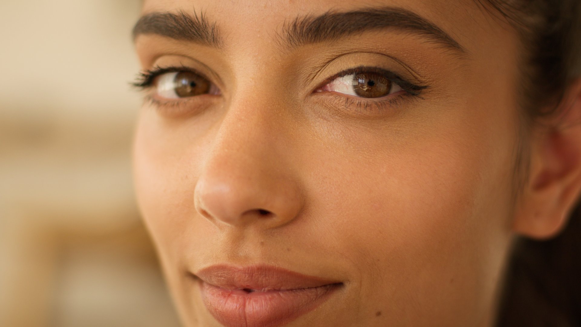 Extreme close up face Indian beautiful healthy woman Arabian satisfied carefree smiling businesswoman business girl medicine health beauty treatment skin care natural make-up looking at camera at home. High quality 4k footage