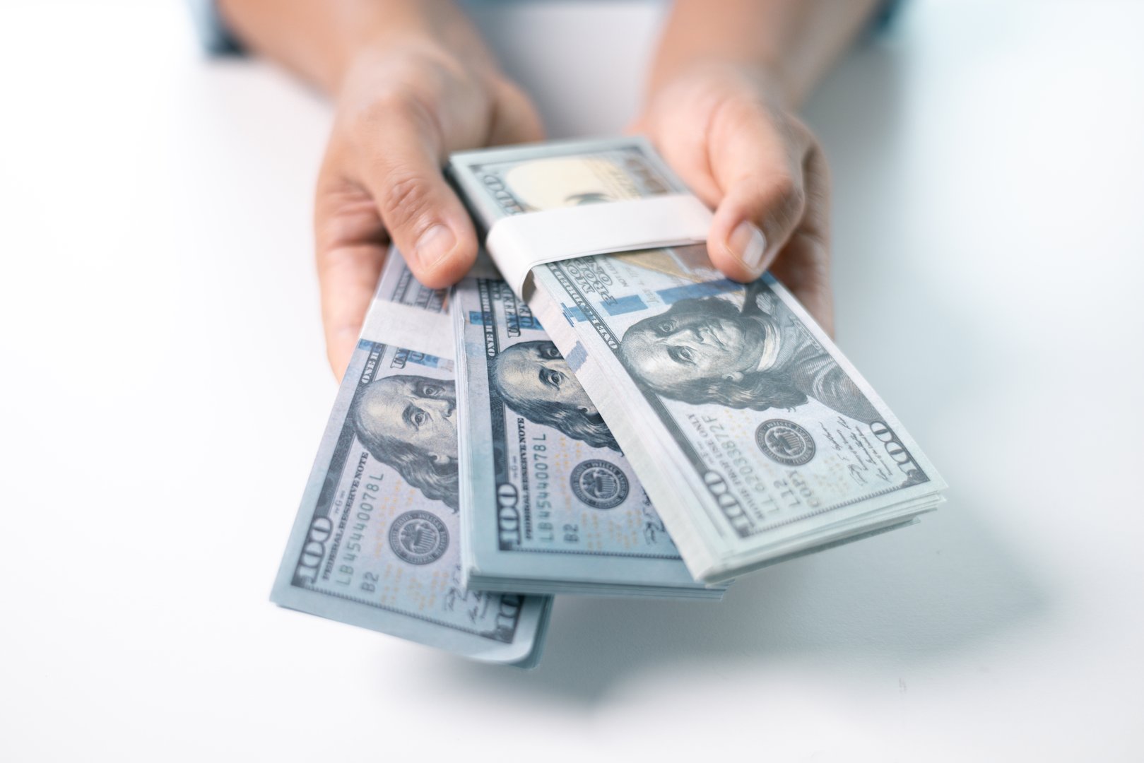 Woman carefully counted the dollar bills in her hand, managing her finances and saving money for future expenses. dollar, hand, money, cash, woman, finance, currency, bill, banknote, saving, business.