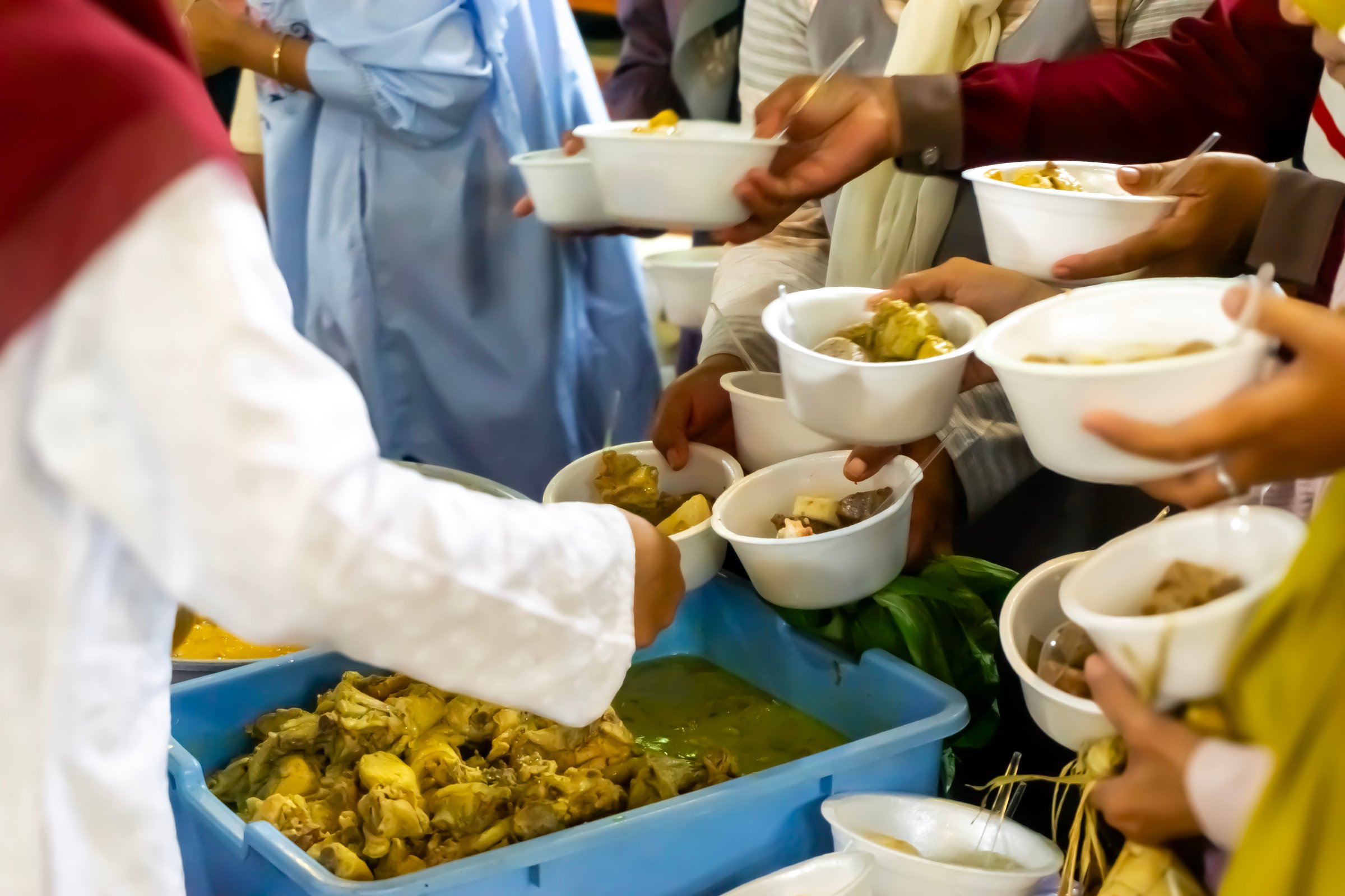 Sharing food on Kirab ketupat. Kirab ketupat is a celebration of Eid al-Fitr by distributing free food