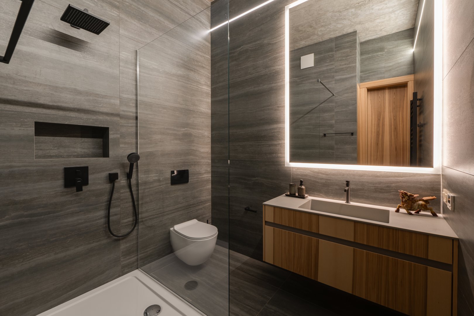 This stylish bathroom showcases sleek lines, a spacious walkin shower, and contemporary organizational storage options