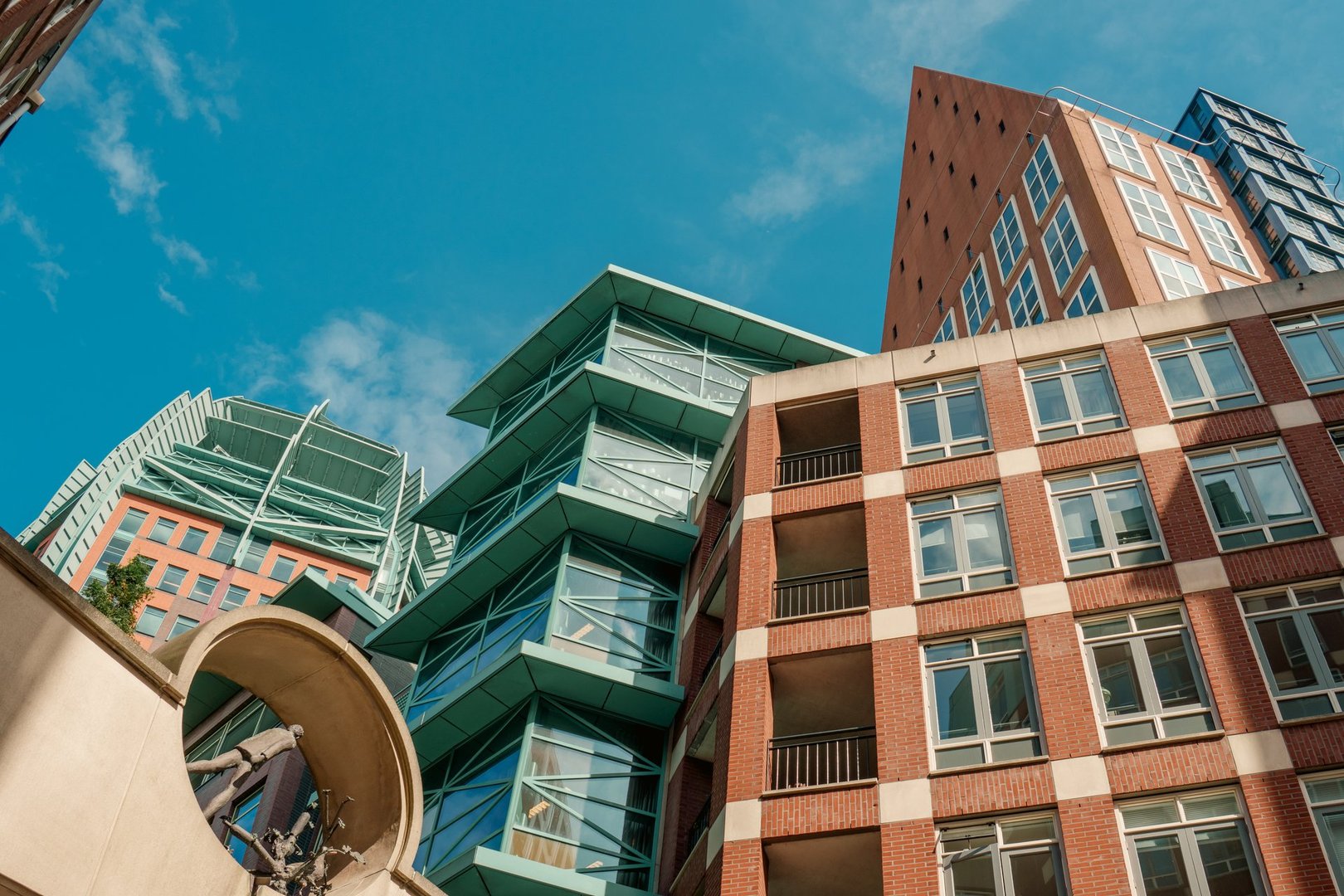 The Hague Netherlands Real Estate District Architecture September 4, 2025. Modern high-rise office and residential buildings with unique geometric shapes and brick facades under clear blue sky. Contemporary architecture in Dutch business center