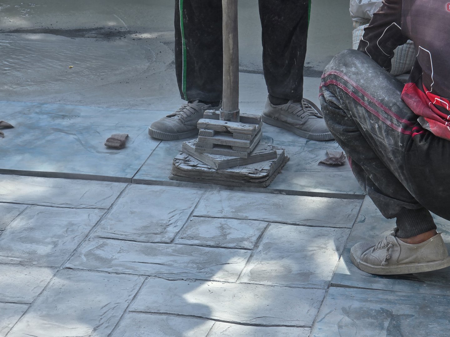 Pattaya, Thailand, skilled artisans are busy working on a stunning stamped concrete surface. The intricate patterns and textures come to life under their expert hands.
