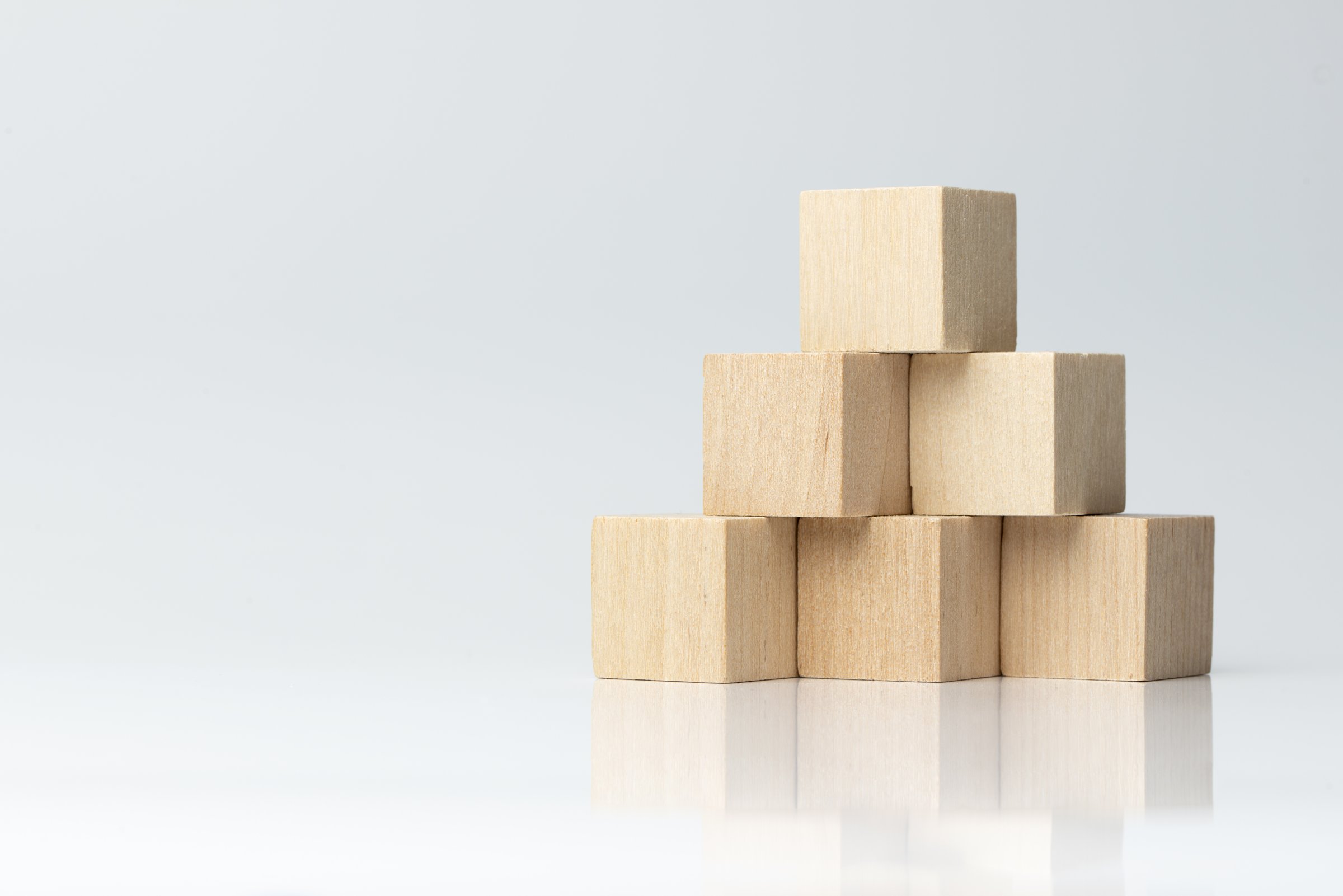 Building blocks arranged in pyramid representing business growth and structure