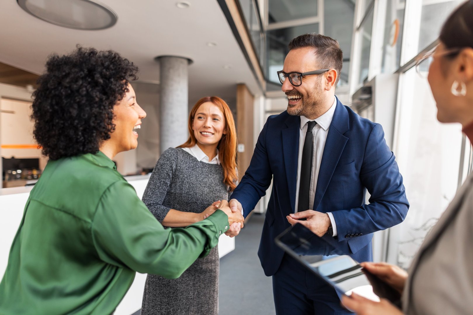 A diverse group of business colleagues engaging and interacting in a modern office space.