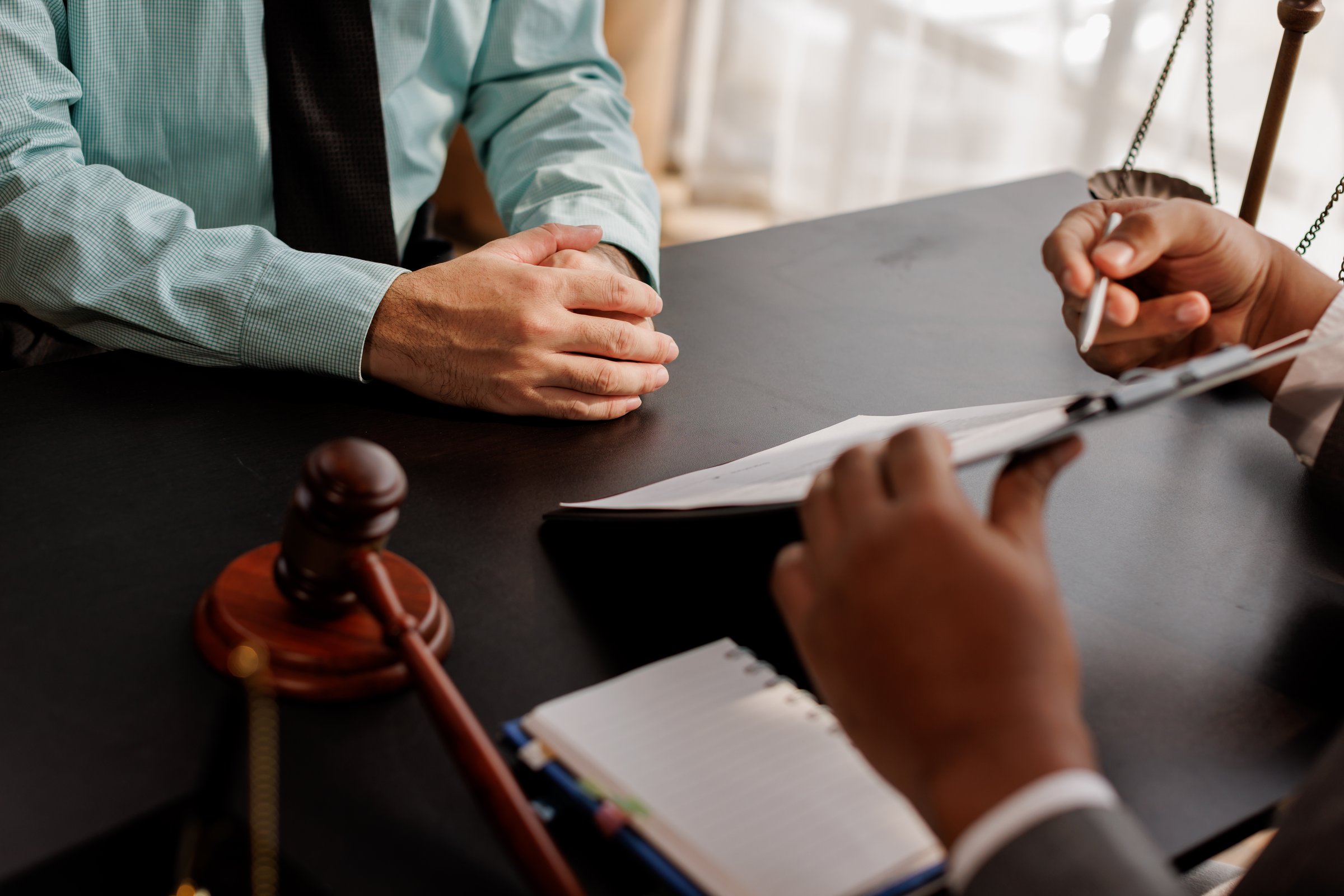 law and justice. Lawyer Legal counsel presents to the client a signed contract with gavel and legal law. justice and lawyer Business partnership meeting concept.