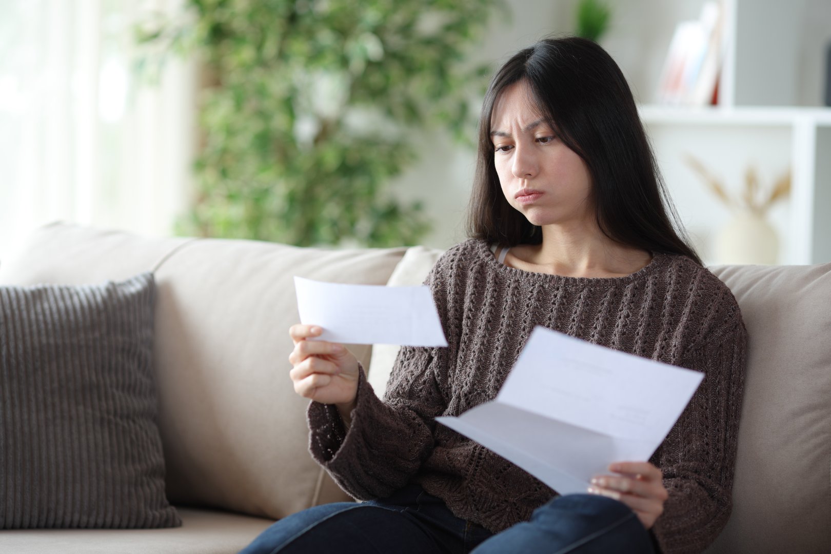 Frustrated homeowner reviewing documents