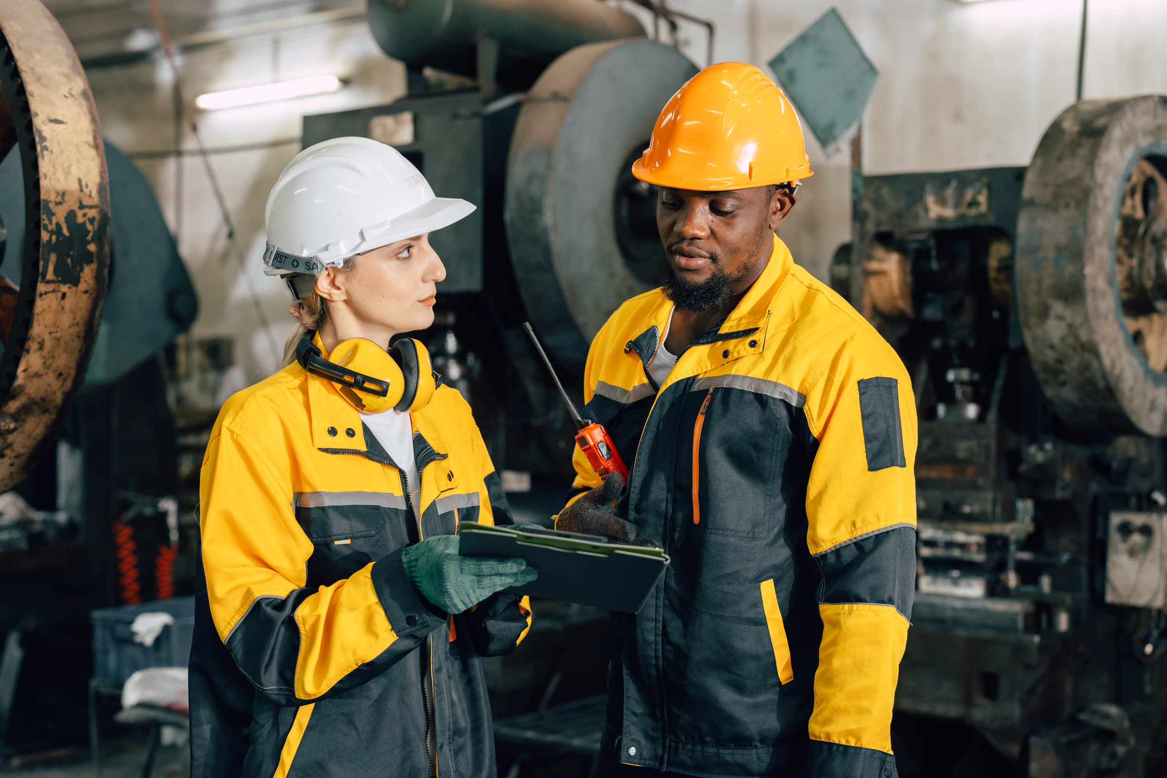 professional engineer team inspecting service machine in heavy industry factory
