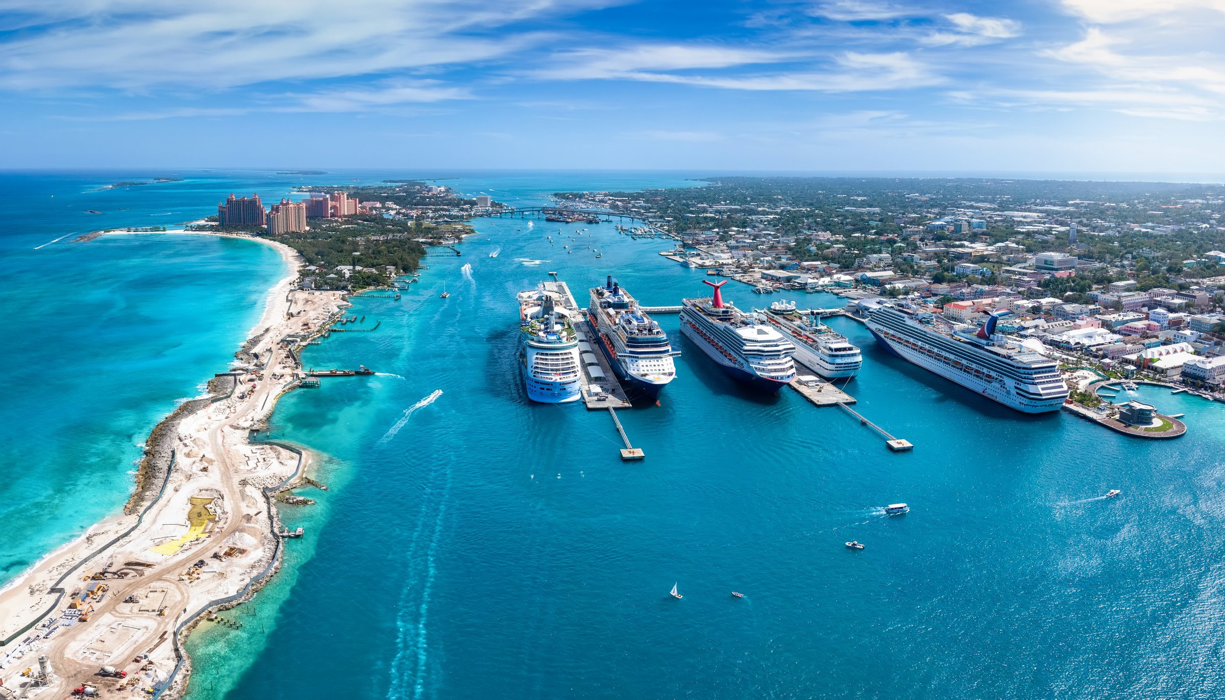 Panoramic aerial view of the port of Nassau with numerous cruise ships lined up and beautiful Paradise island