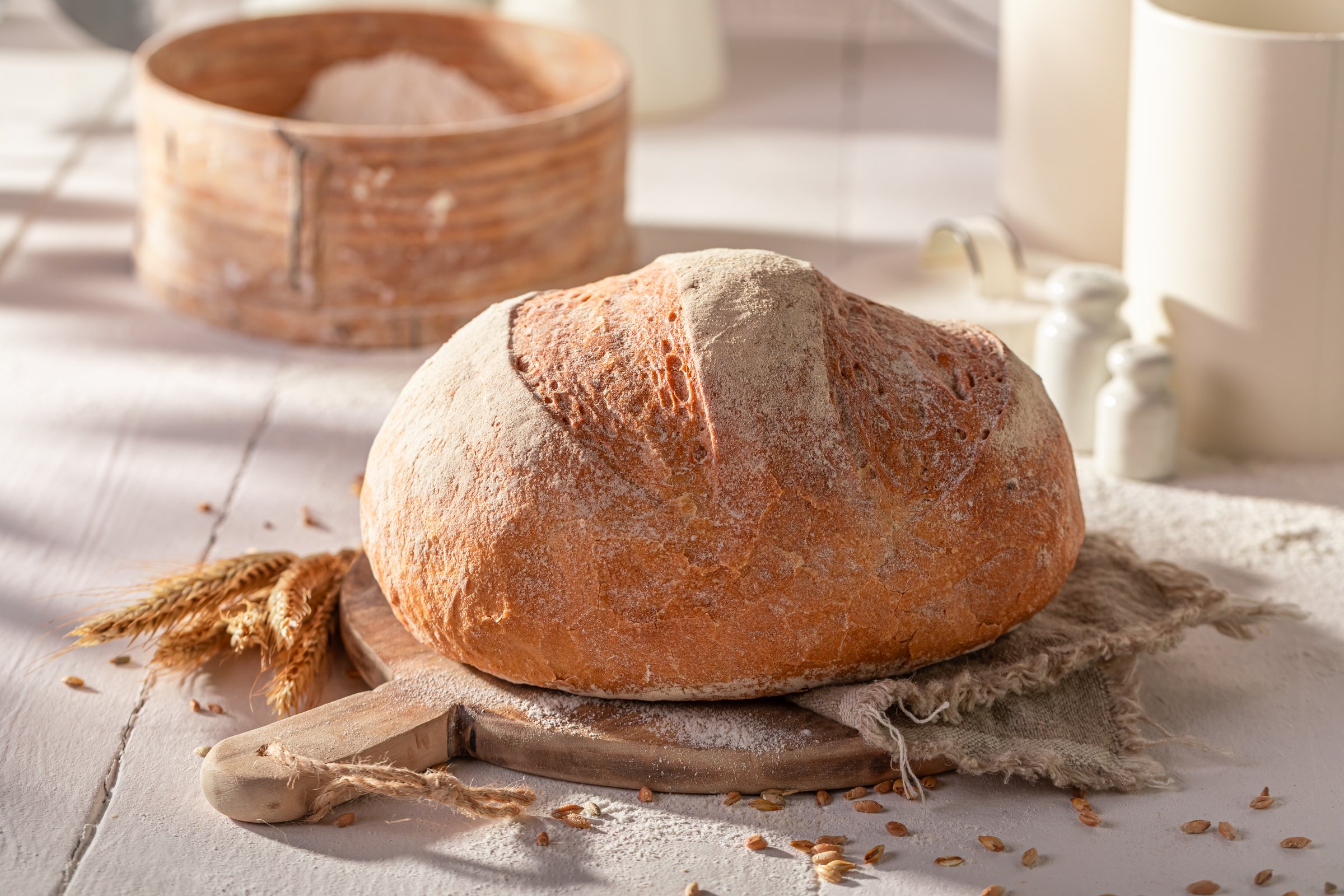 Crispy and rustic round loaf bread baked in rustic kitchen. Homemade bread.
