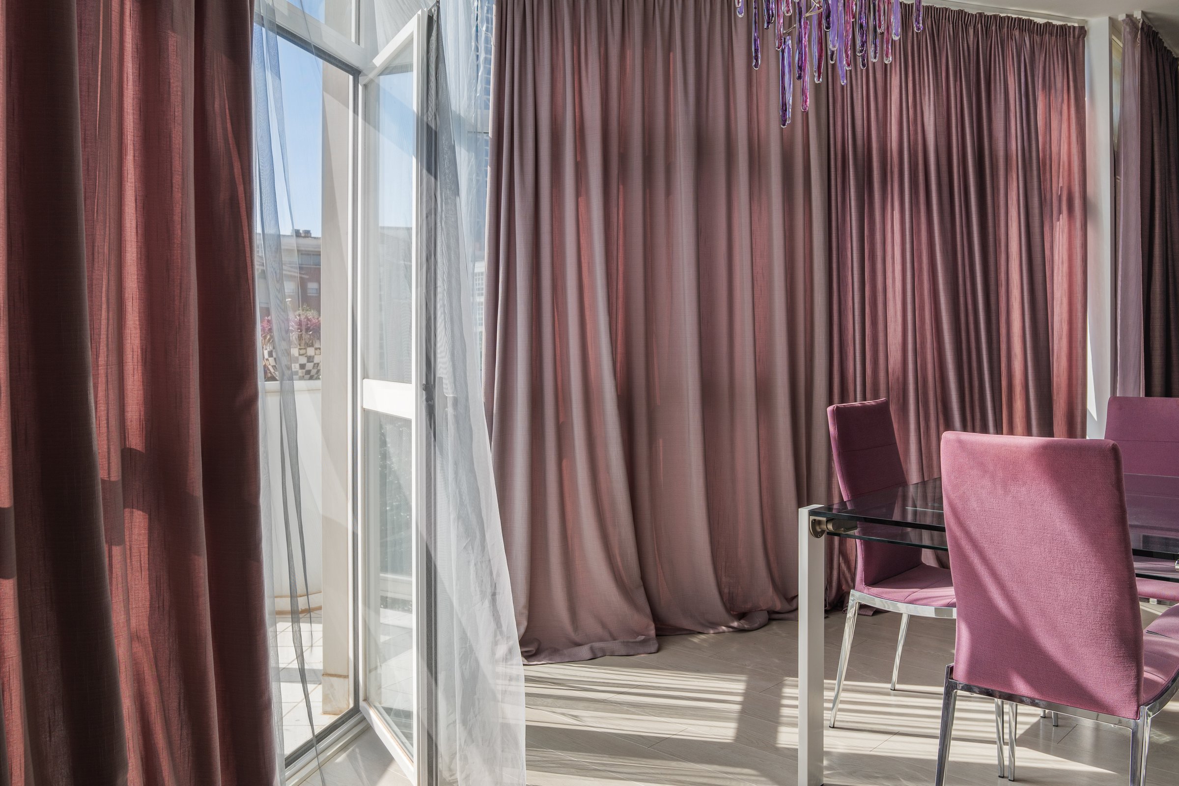 The sunlight through the fabric shade curtains on daytime. Summer and sunny day in a living room concept