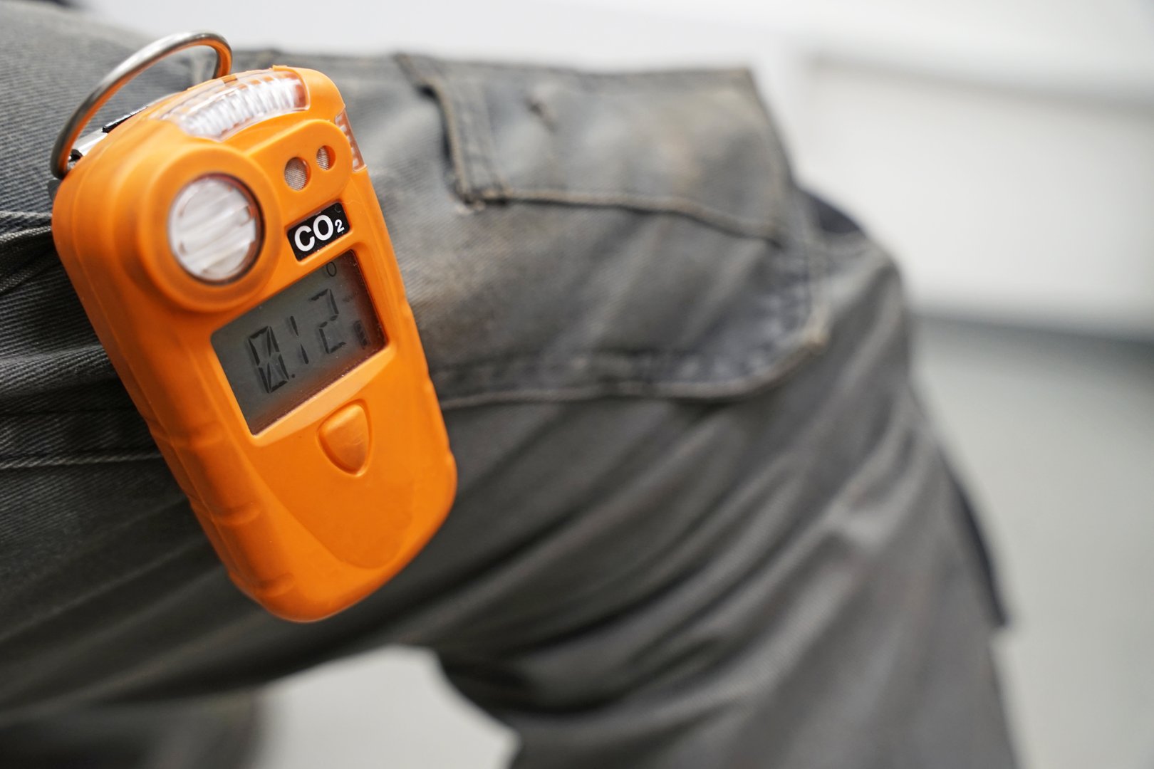 Co2 safety personal portable gas monitor and detector attached to worker's trousers