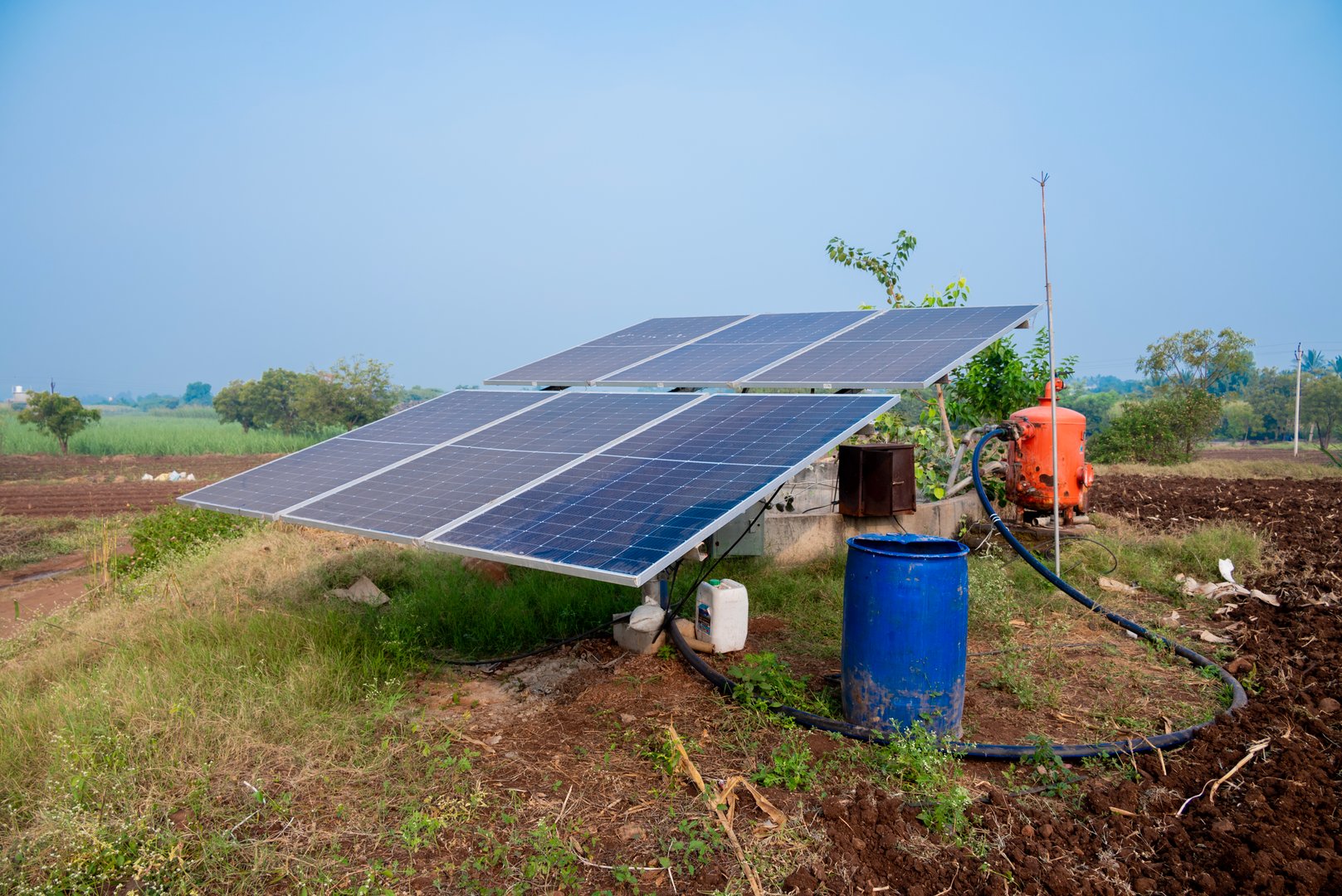 Solar powered panels are installed in farmlands or fields or farms. Rows of sustainable energy solar panels installed on farmland meadow rural field