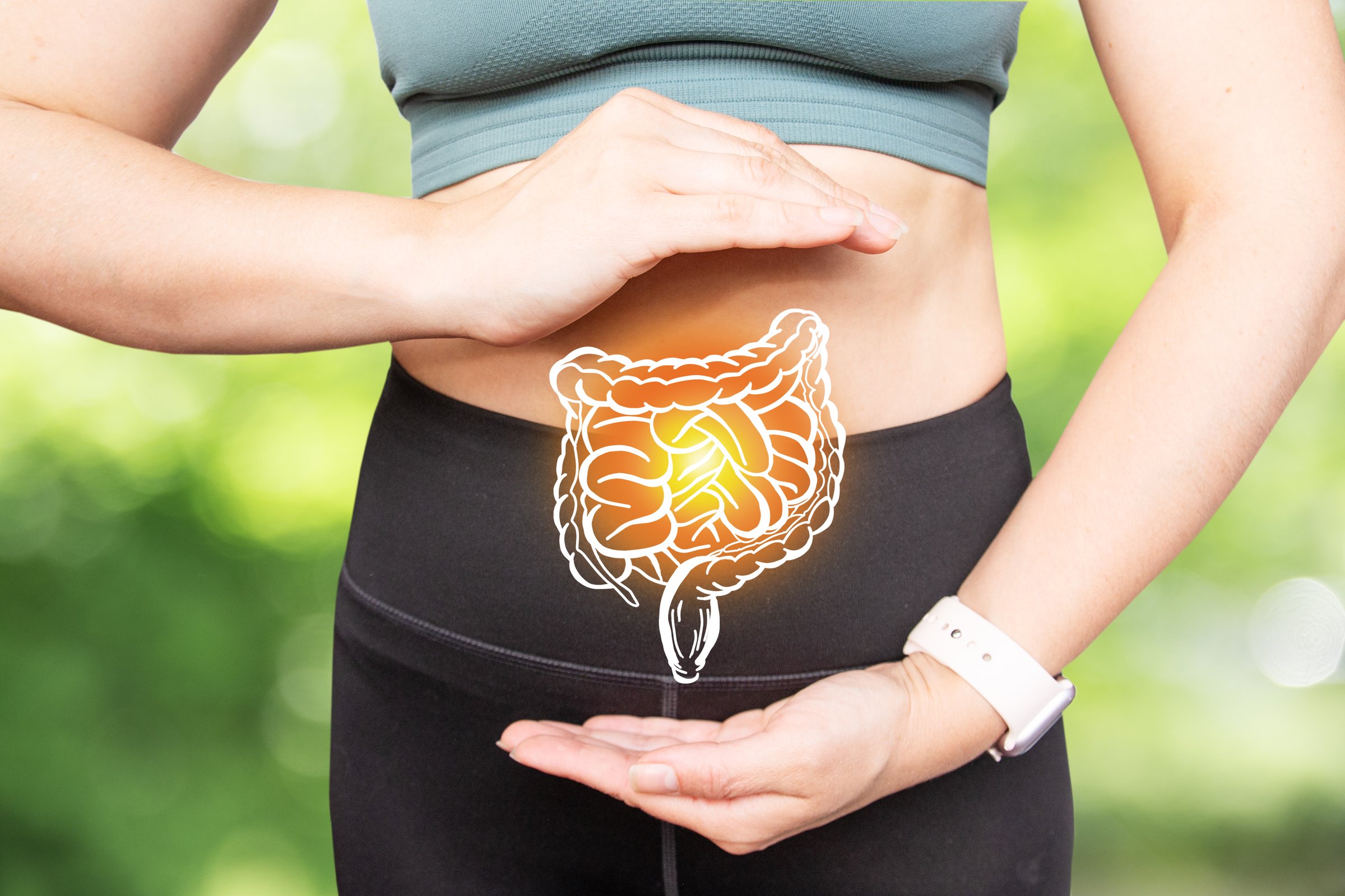 A girl in sportswear on a natural background, a projection of the intestine. Sports and proper nutrition for good health and longevity. A healthy lifestyle.