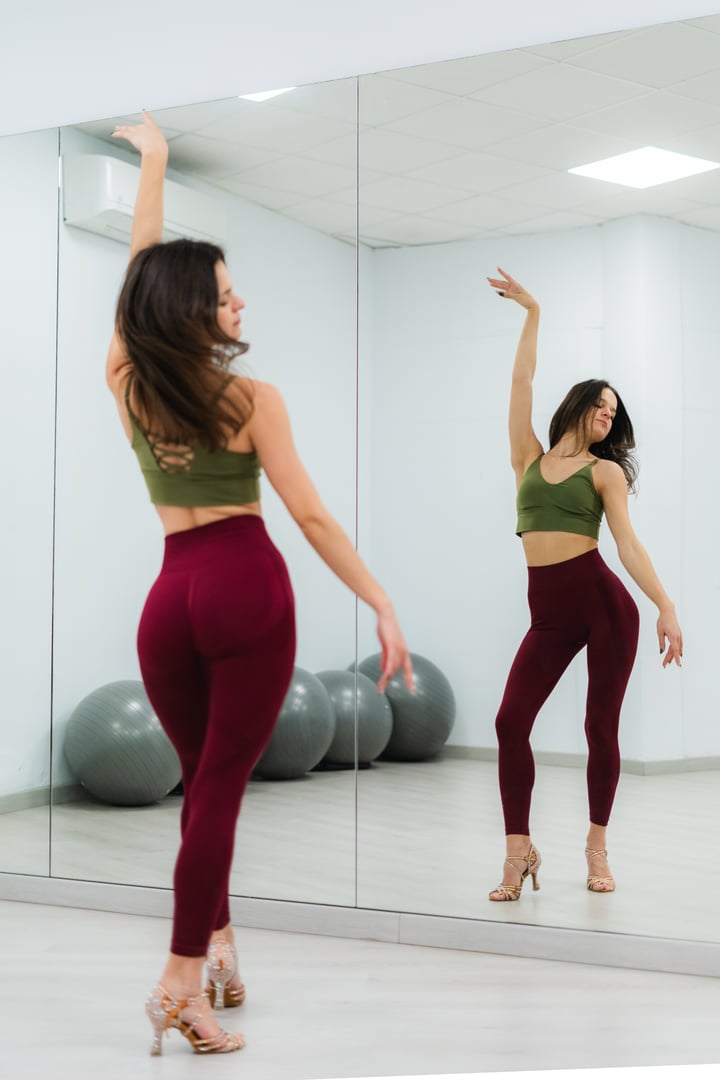 Young woman practicing a latin dance choreography in a dance studio