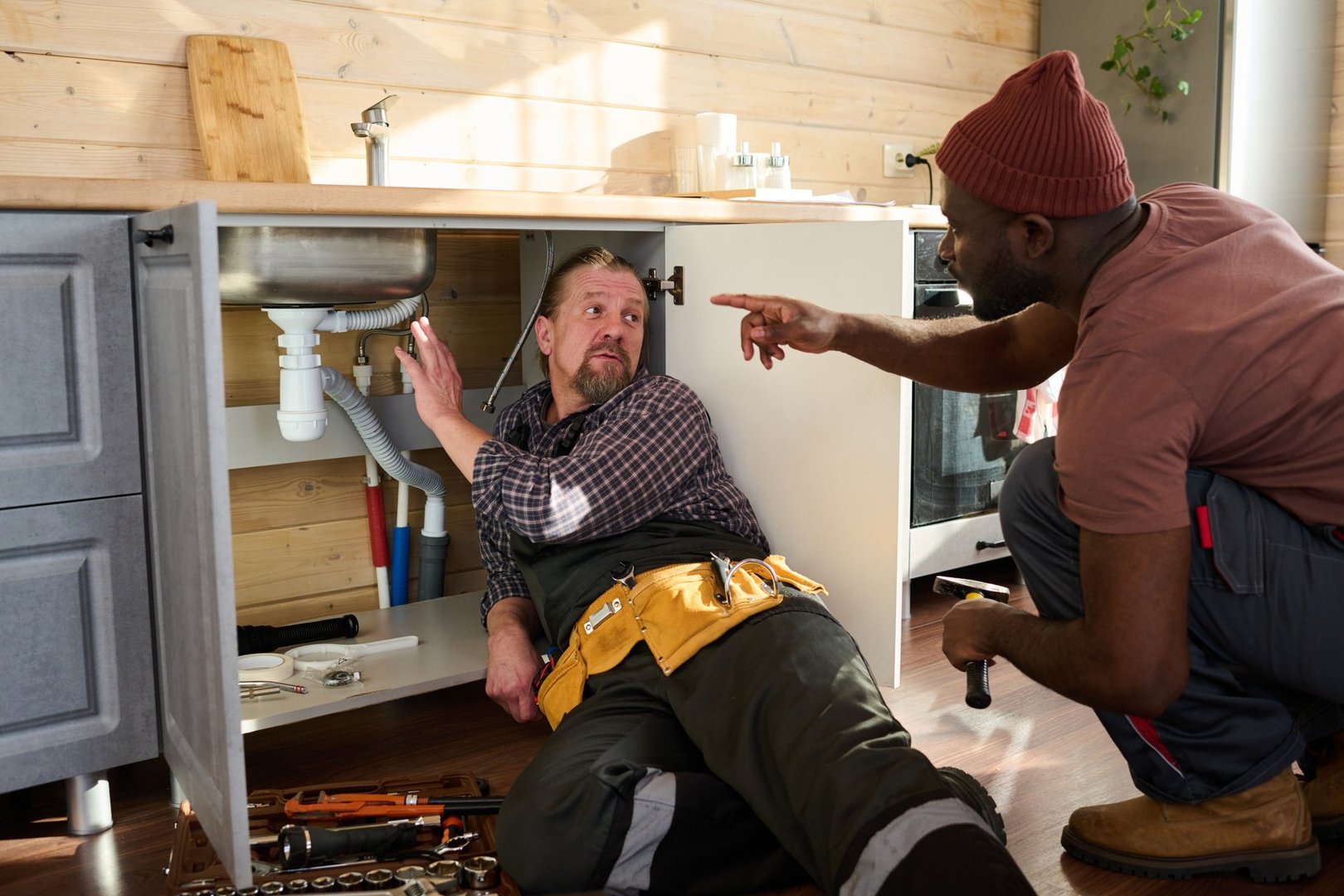 Professional plumber explaining work to customer