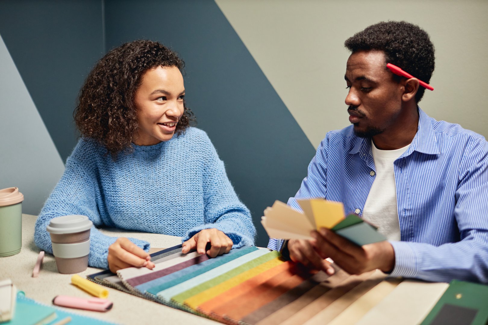 Paint color selection tips - Interior designers choosing paint colors with fabric samples for professional painting project