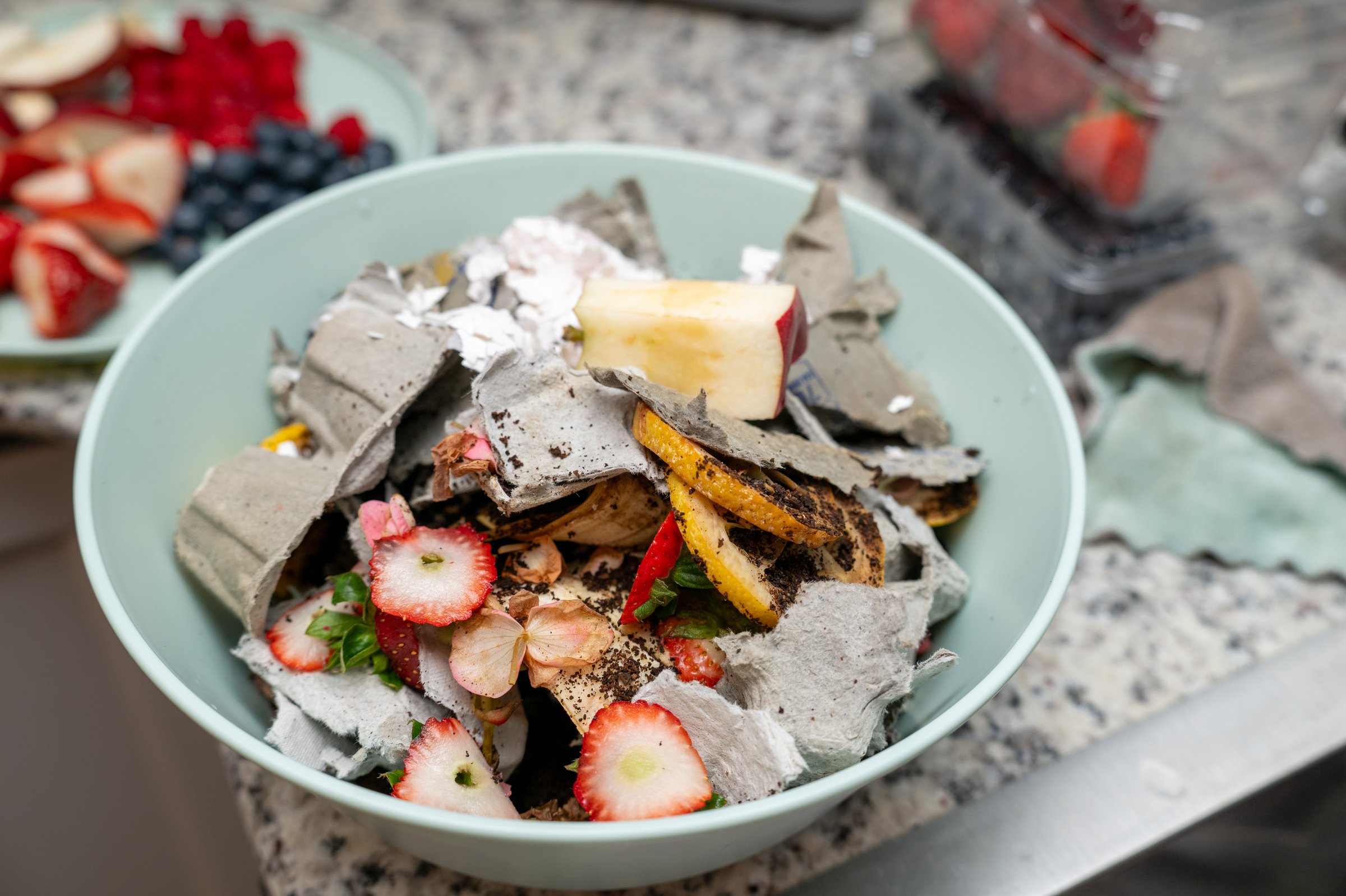 Composting kitchen scraps to reuse and recycle food leftovers into healthy garden soil. Environment safety concept.