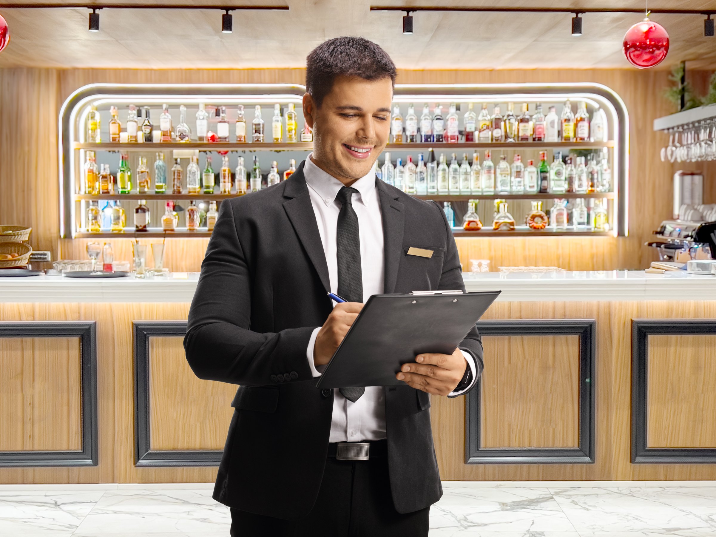 Manager writing a document at a bar